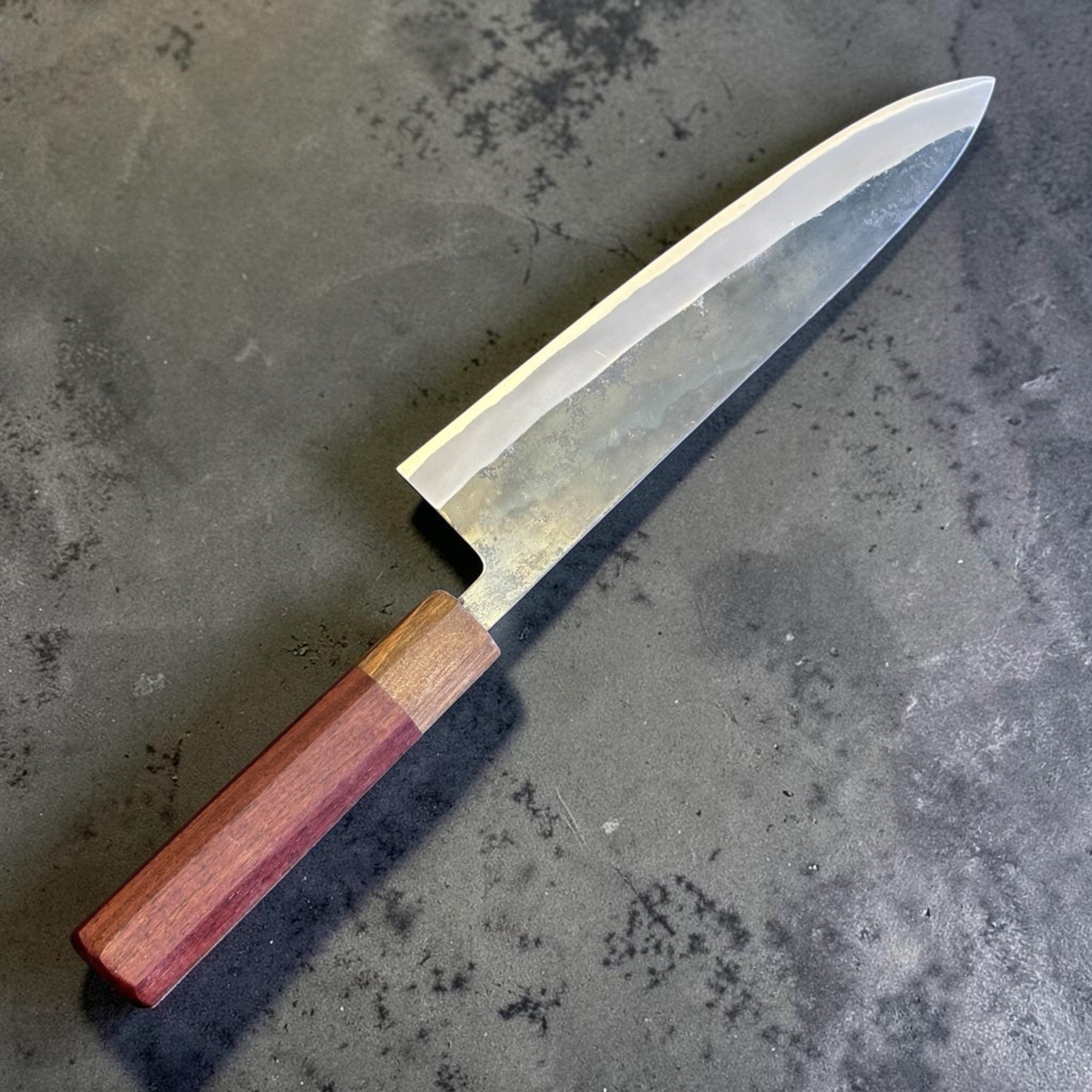Tokushu Knife Rosewood Series White #2 Kurouchi 210 mm Japanese gyuto knife, angled front view showing kurouchi finish and rosewood wa handle.