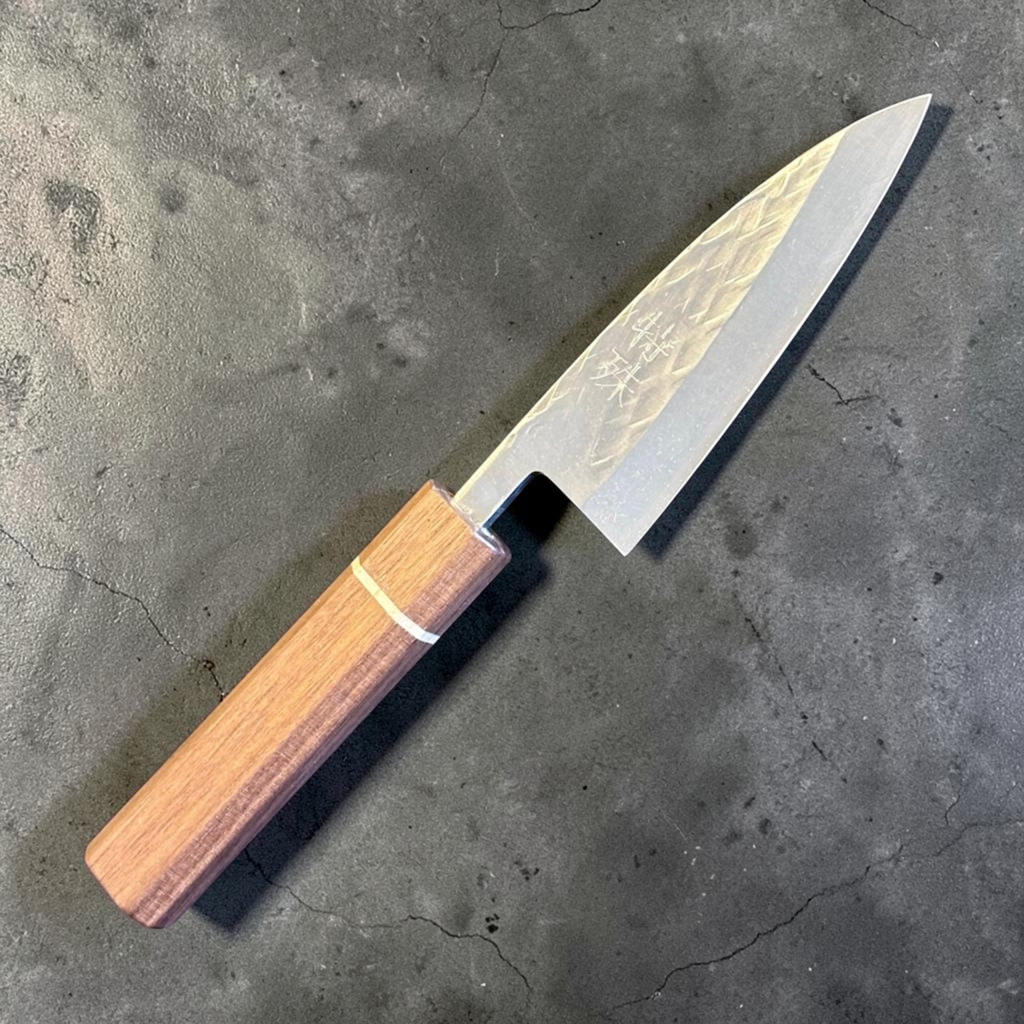 Tokushu Knife Tsuchime SLD 105 mm Tall Petty Ajikiri, angled view highlighting the compact tall petty shape and octagonal wood handle.