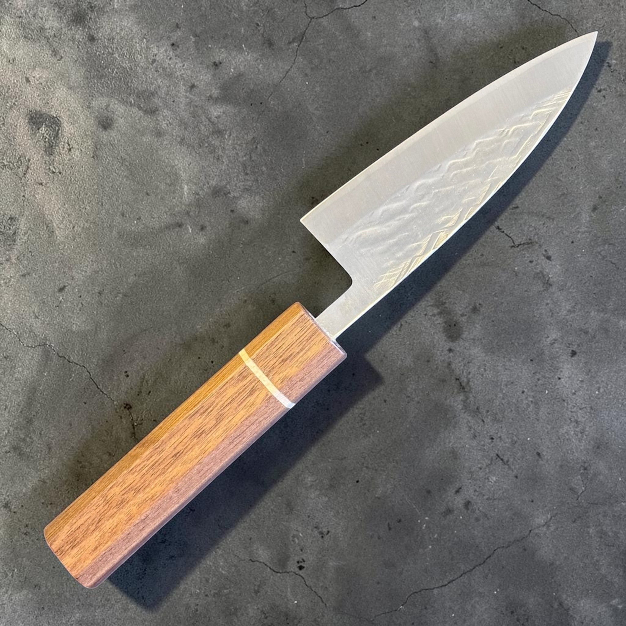 Tokushu Knife Tsuchime SLD 105 mm Tall Petty Ajikiri, angled reverse-side view showing the hammered tsuchime pattern and handle detail.