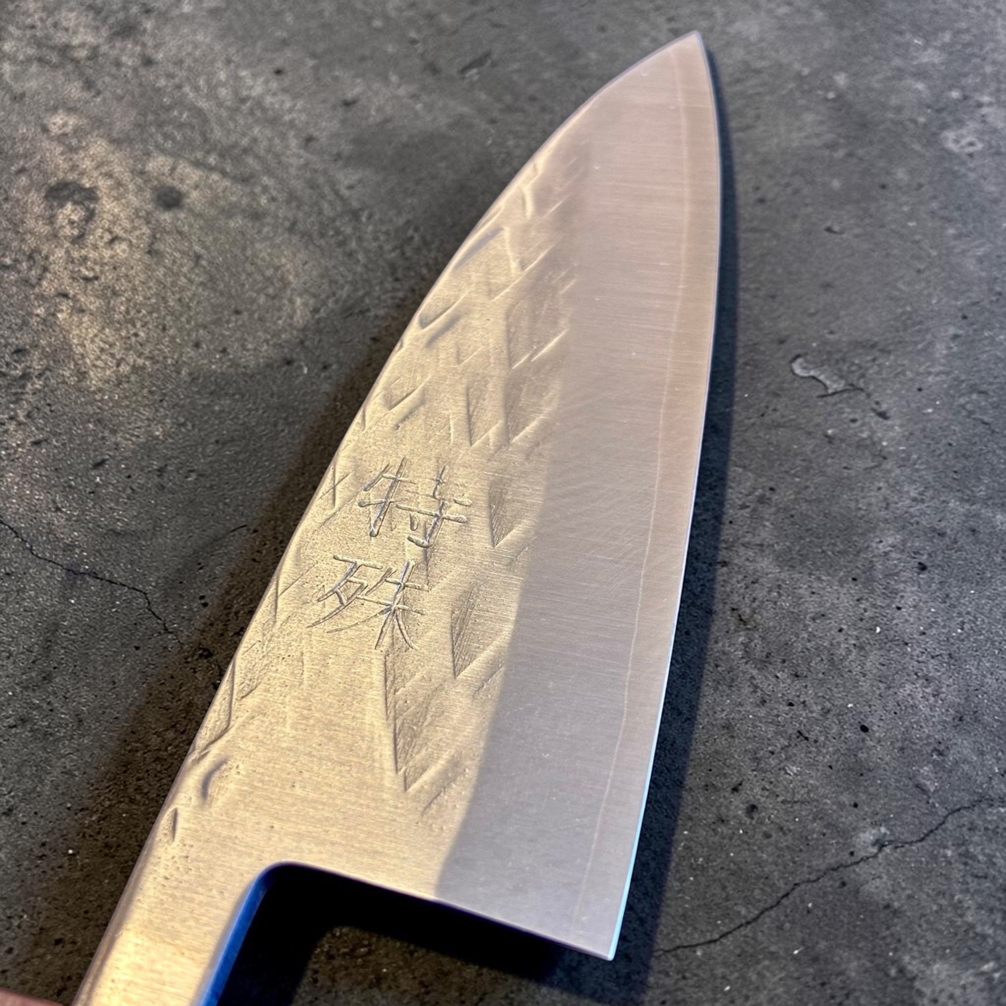 Tokushu Knife Tsuchime SLD 105 mm Tall Petty Ajikiri, close-up of the blade face with engraved kanji, edge line, and hammered finish.
