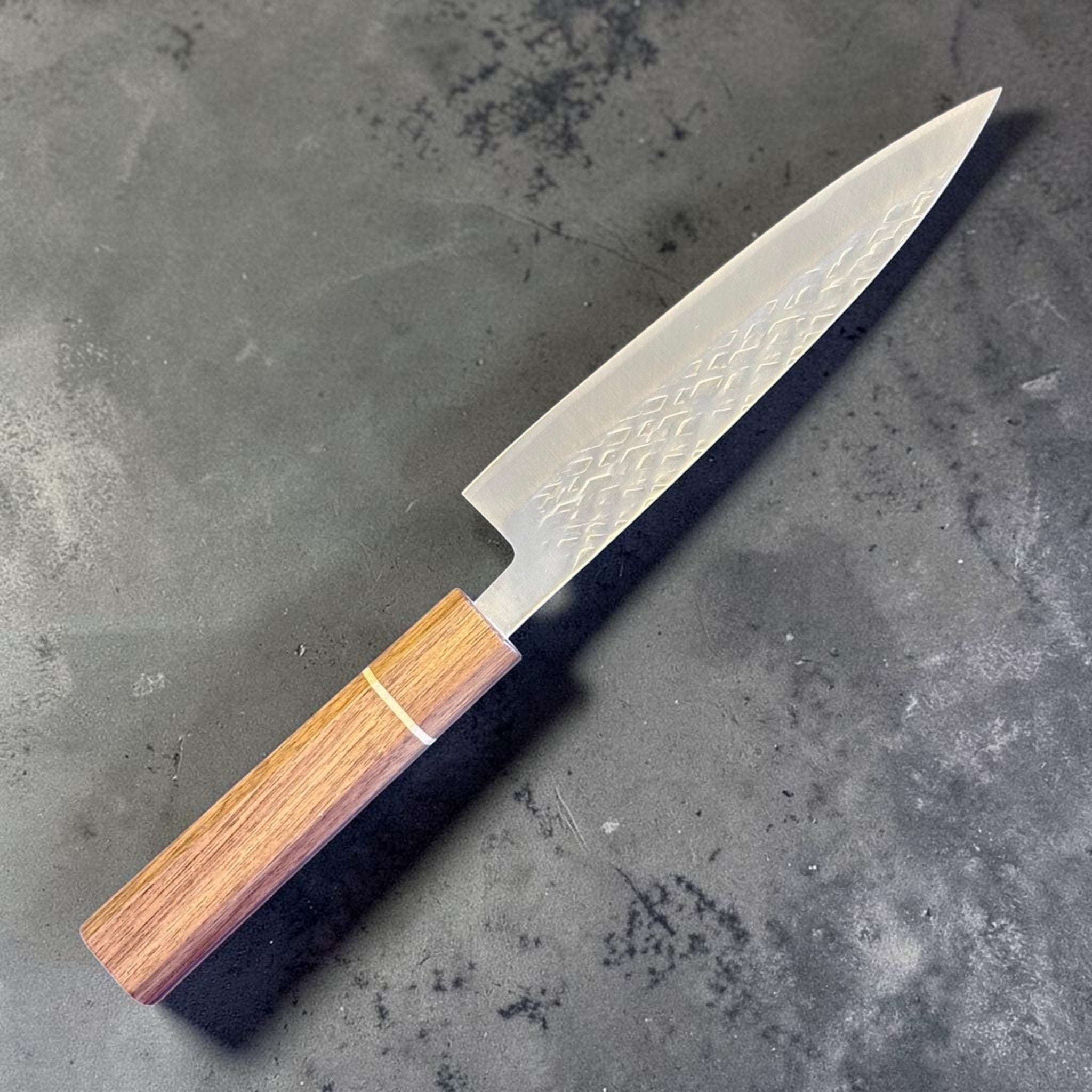 Tokushu Knife Tsuchime SLD 165 mm Hiraki Petty, angled reverse-side view with engraved kanji, hammered blade texture, and clean edge line.