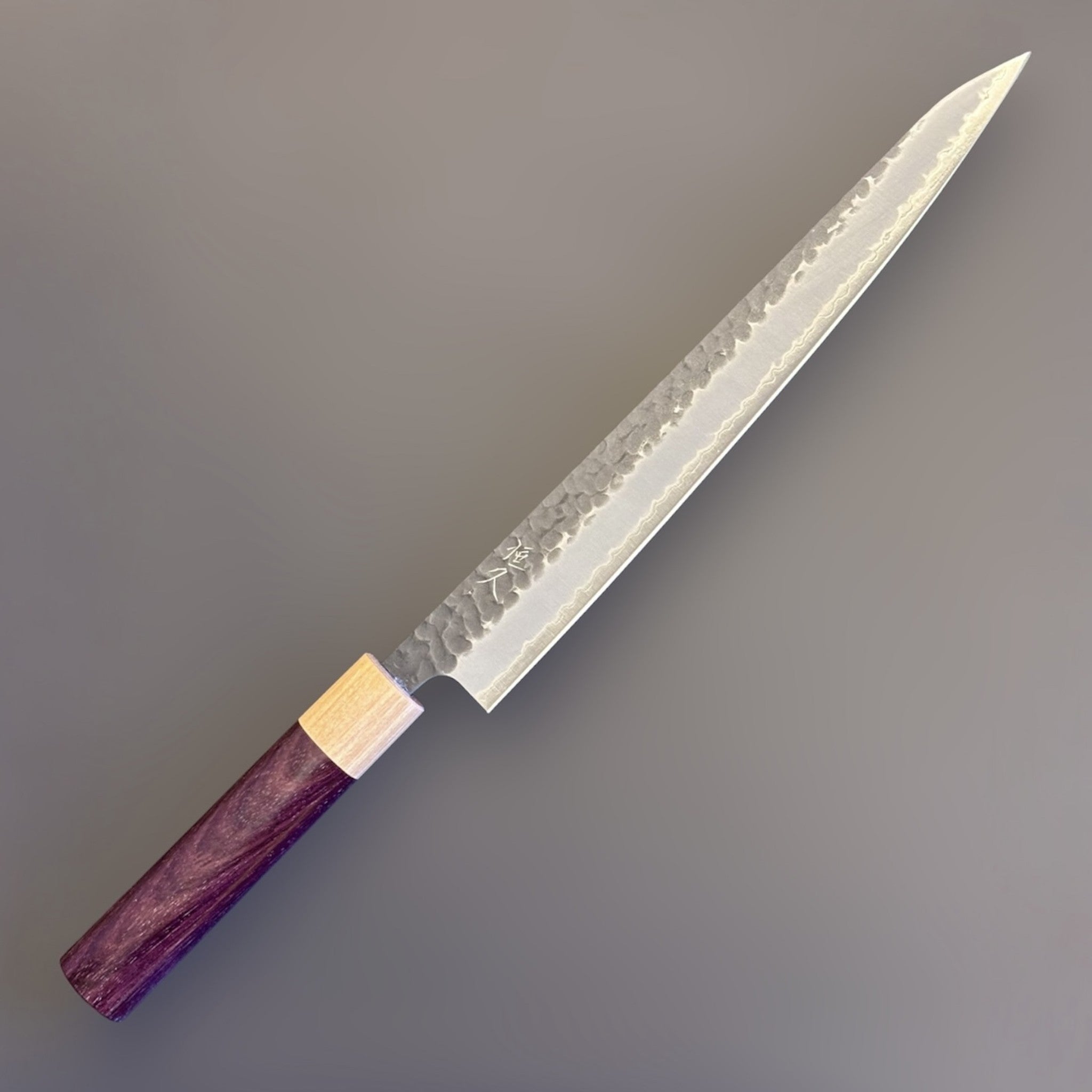 Tsunehisa Aogami Super Tsuchime Kurouchi Sujihiki 270 mm, angled close-up of blade and handle.