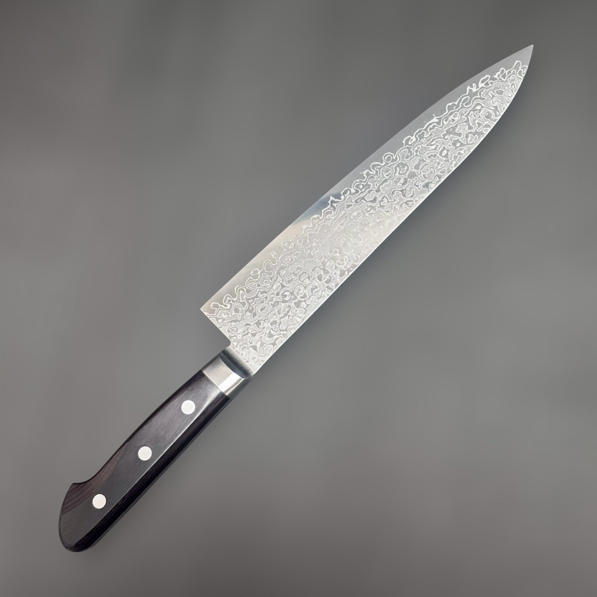 Tsunehisa AUS-10 Damascus Gyuto 210 mm, angled shot highlighting Damascus pattern and maker's mark on the blade.