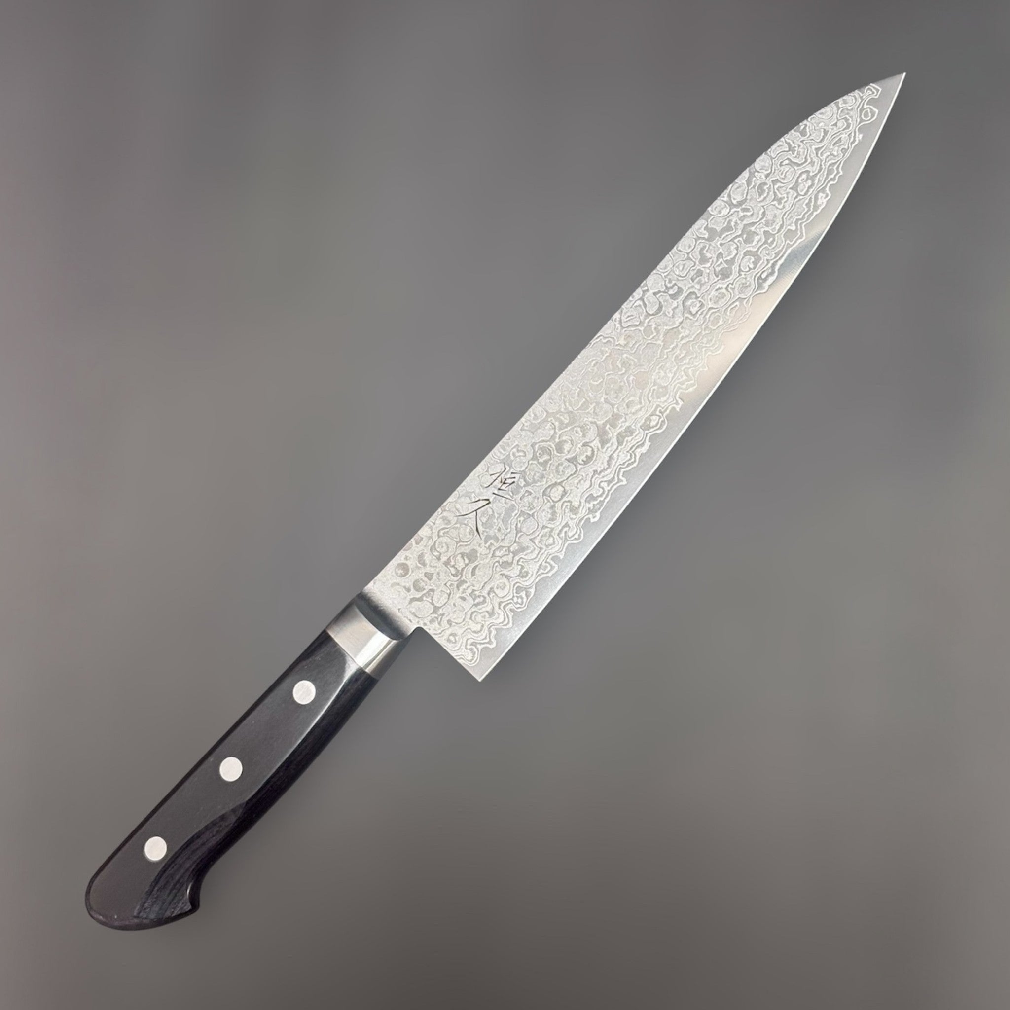 Tsunehisa AUS-10 Damascus Gyuto 210 mm, angled hero shot showing blade profile and western handle.