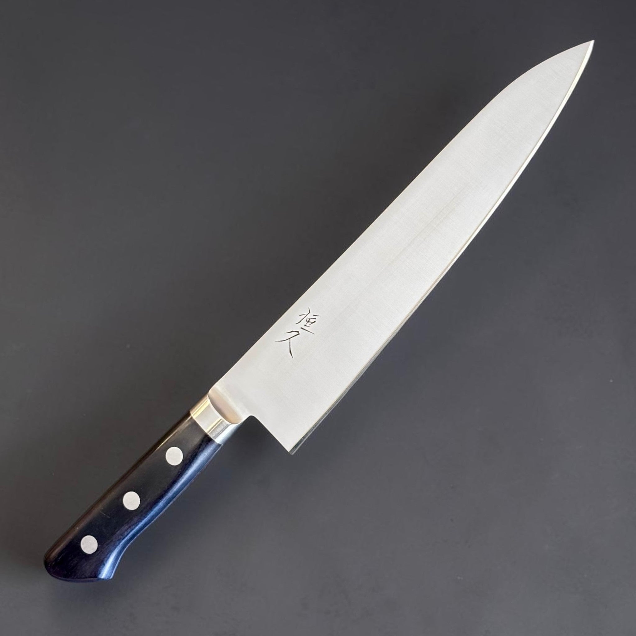 Tsunehisa Mono AUS-8 Gyuto 210 mm with black Western handle, angled full knife view showing the blade face, kanji, and black Western handle.