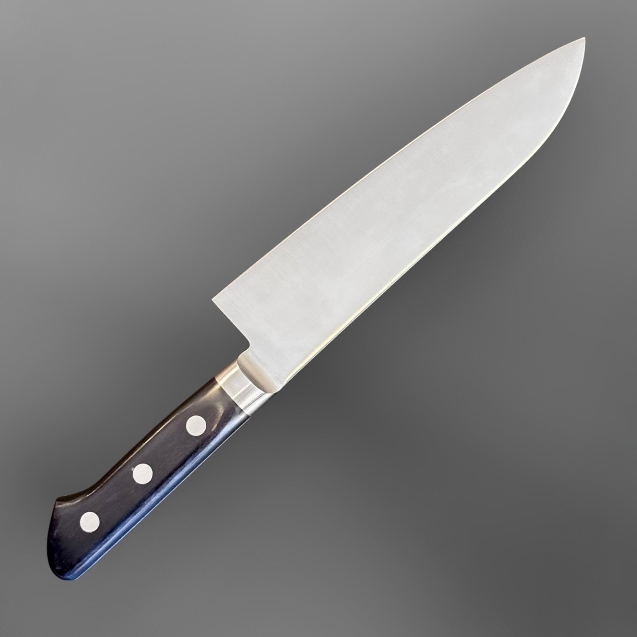 Tsunehisa Mono AUS-8 Santoku 165 mm with black Western handle, angled blade view with black Western handle and stainless bolster.