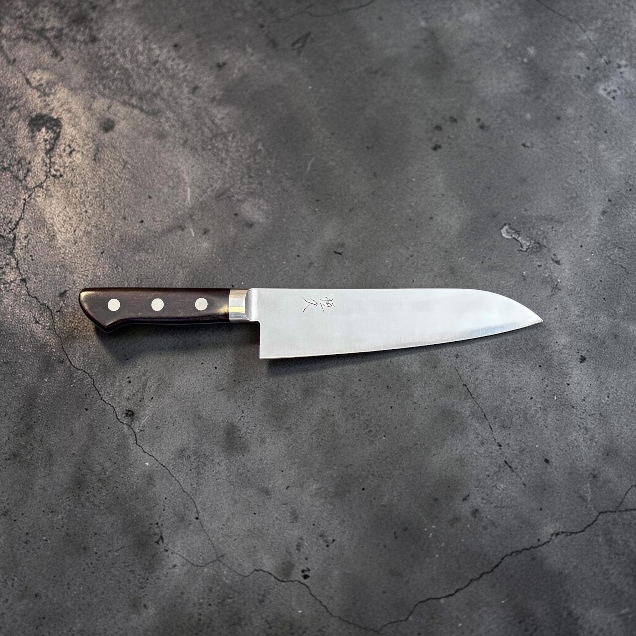 Tsunehisa Mono AUS-8 Santoku 165 mm with black Western handle, full side profile showing the santoku blade shape and handle rivets.