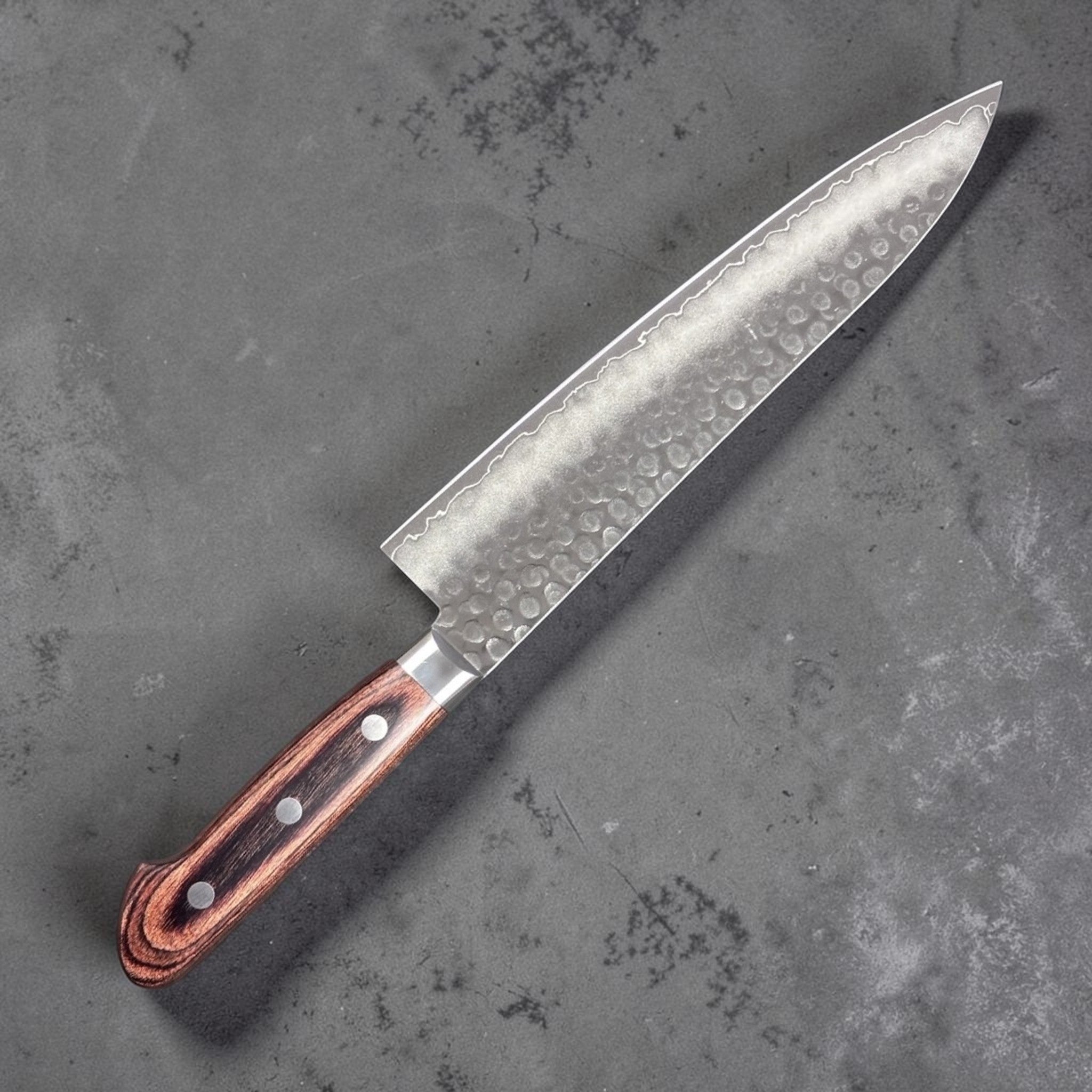 Tsunehisa VG-10 Tsuchime Gyuto 210 mm with brown Western handle, left-side face showing hammered finish and gentle cladding line.