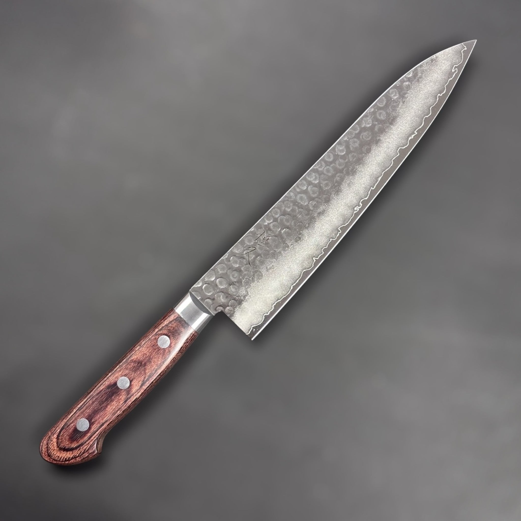 Tsunehisa VG-10 Tsuchime Gyuto 210 mm with brown Western handle, right-side face with hammered tsuchime texture and maker’s mark.