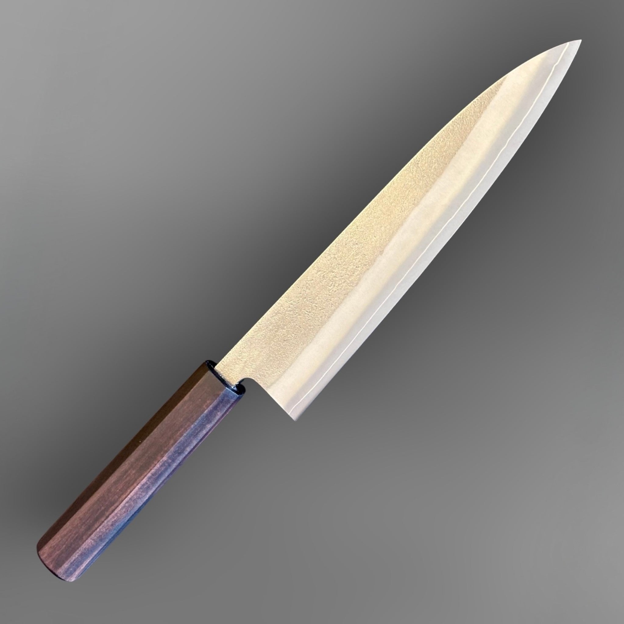 Yoshikane SKD Nashiji Gyuto 210 mm with mono ebony handle, angled front-side view showing nashiji blade finish.