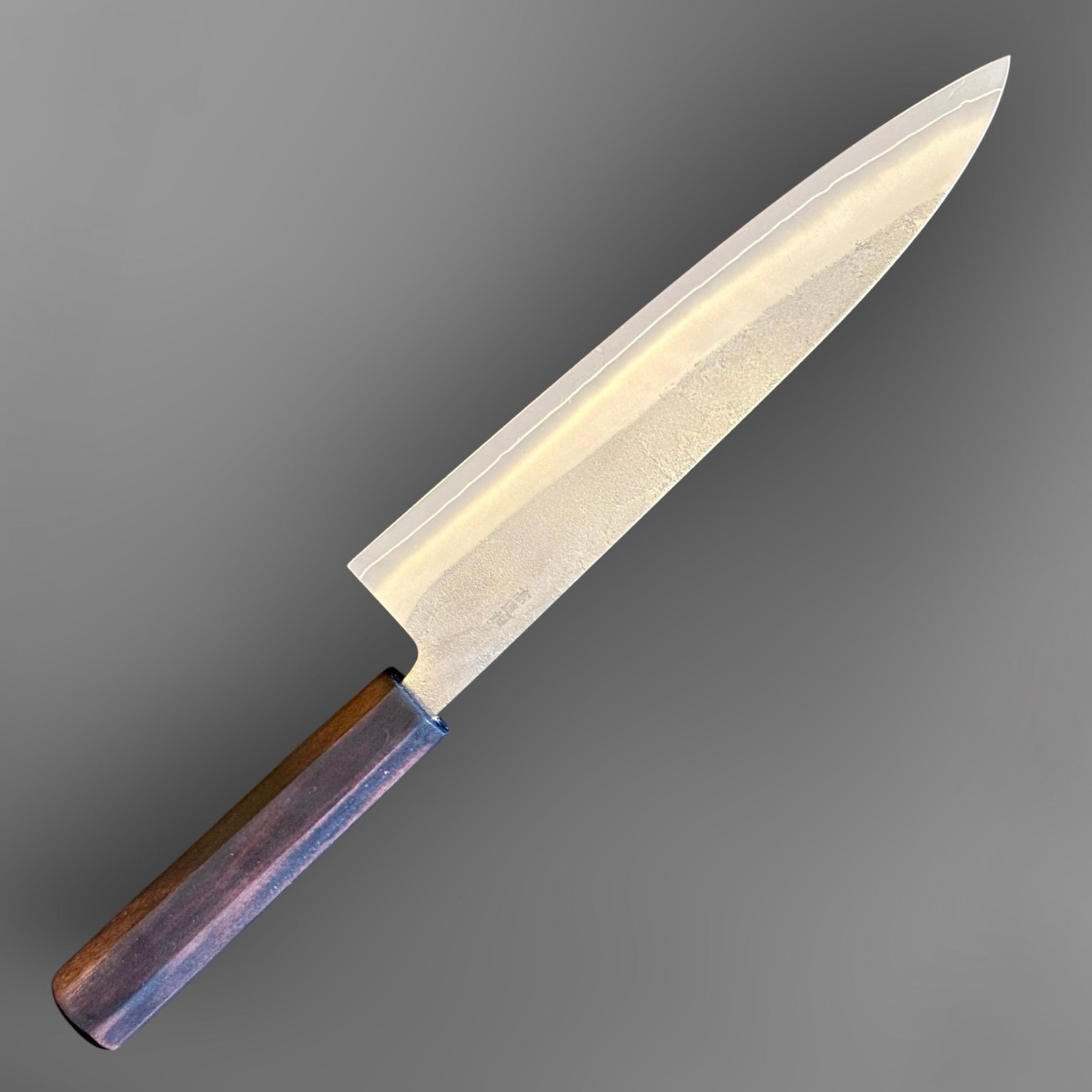 Yoshikane SKD Nashiji Gyuto 210 mm with mono ebony handle, angled reverse-side view showing blade profile and kanji.