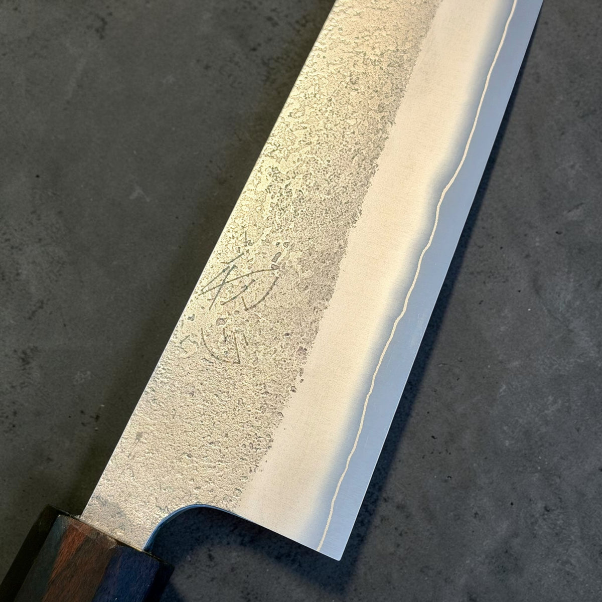 Yoshikane SKD Nashiji Gyuto 240mm close-up of the SKD edge steel and stainless nashiji cladding.