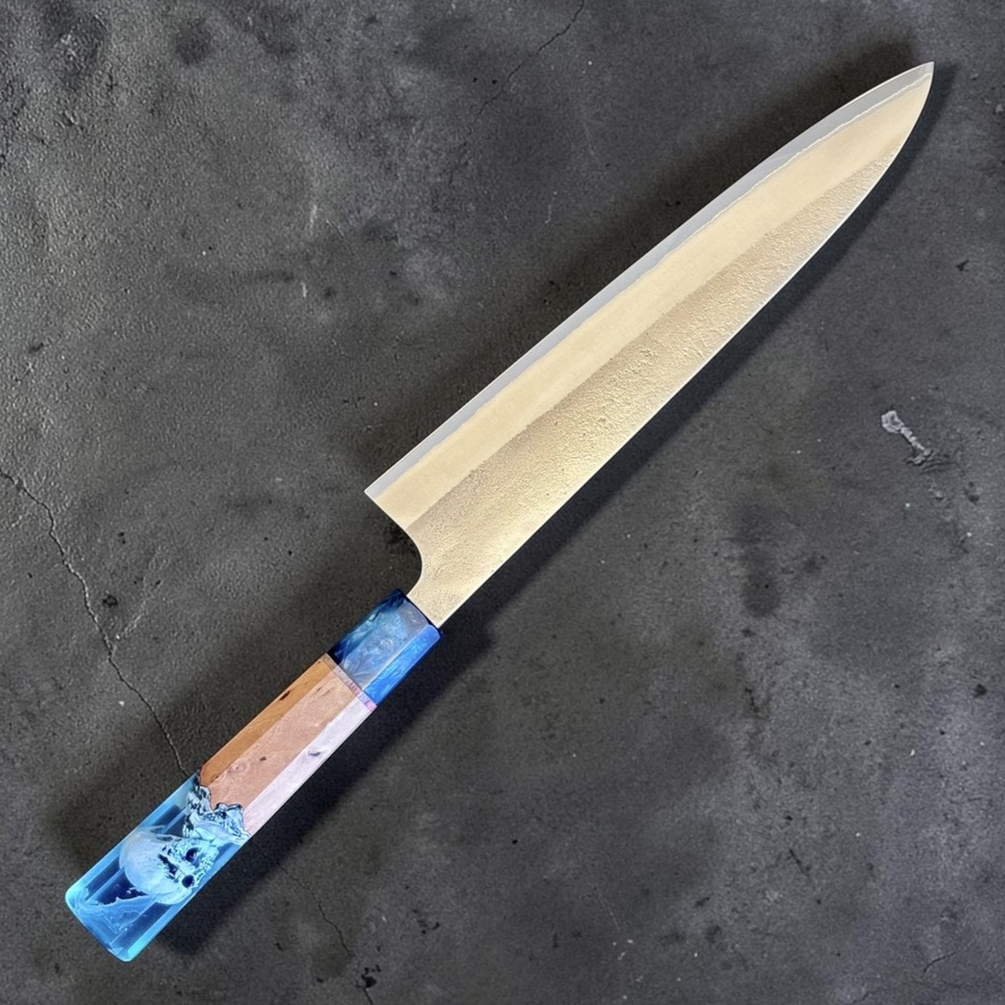Yoshikane White #2 Nashiji Gyuto 240 mm with Prisma Blue Mountain handle, angled blade view highlighting the nashiji finish and long gyuto profile.