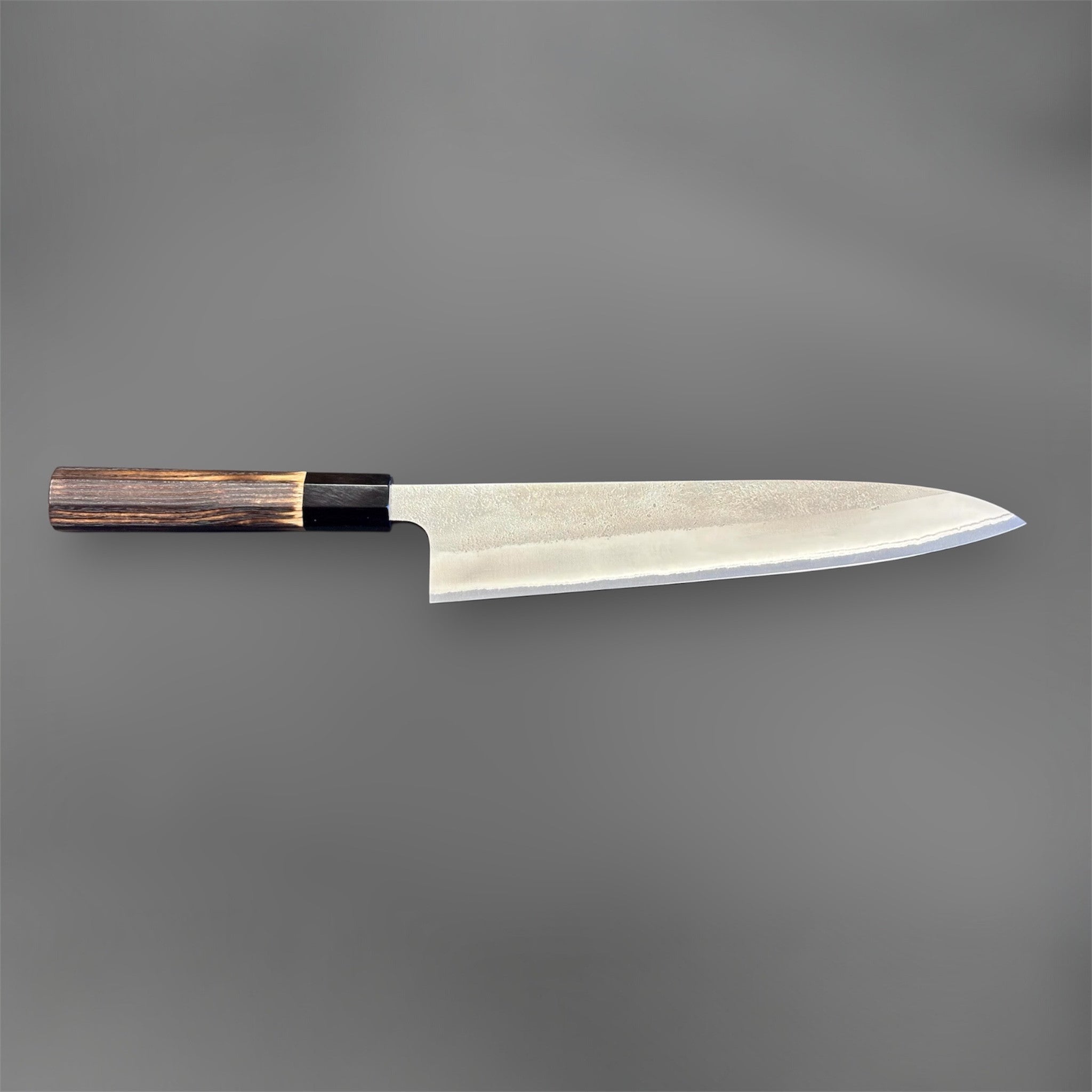 Yoshikane White #2 Nashiji Gyuto 240 mm, close-up of the heel area showing the Nashiji finish, polished bevel, and choil transition.