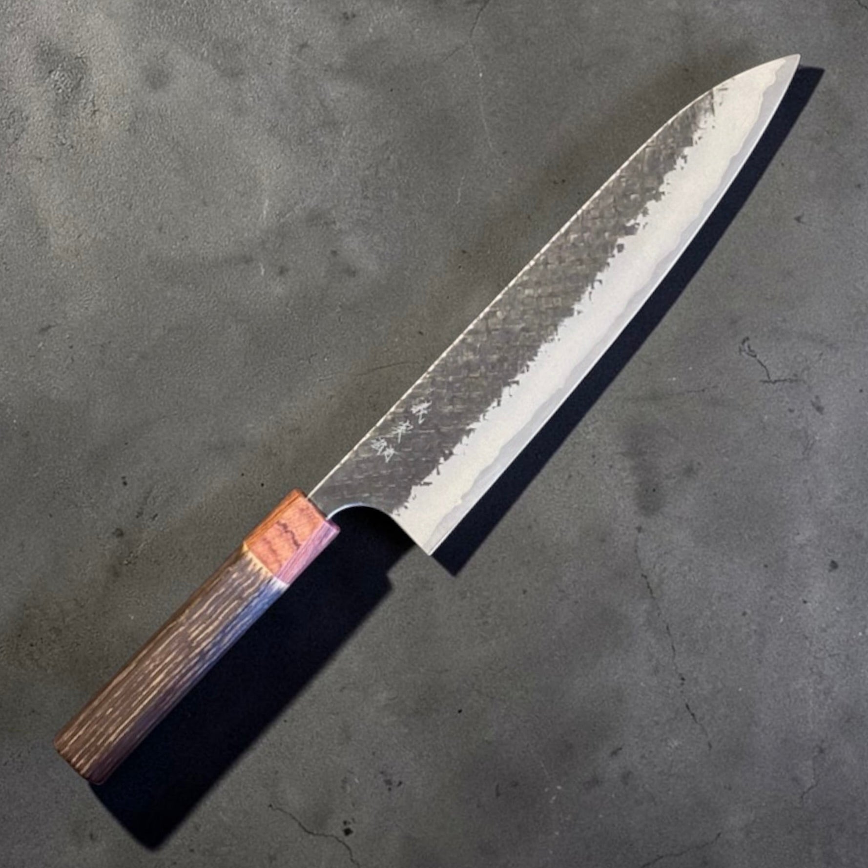 Yoshimi Kato Aogami Super Kurouchi Kaku-Tsuchime Gyuto 240mm with burnt chestnut handle, angled hero view.