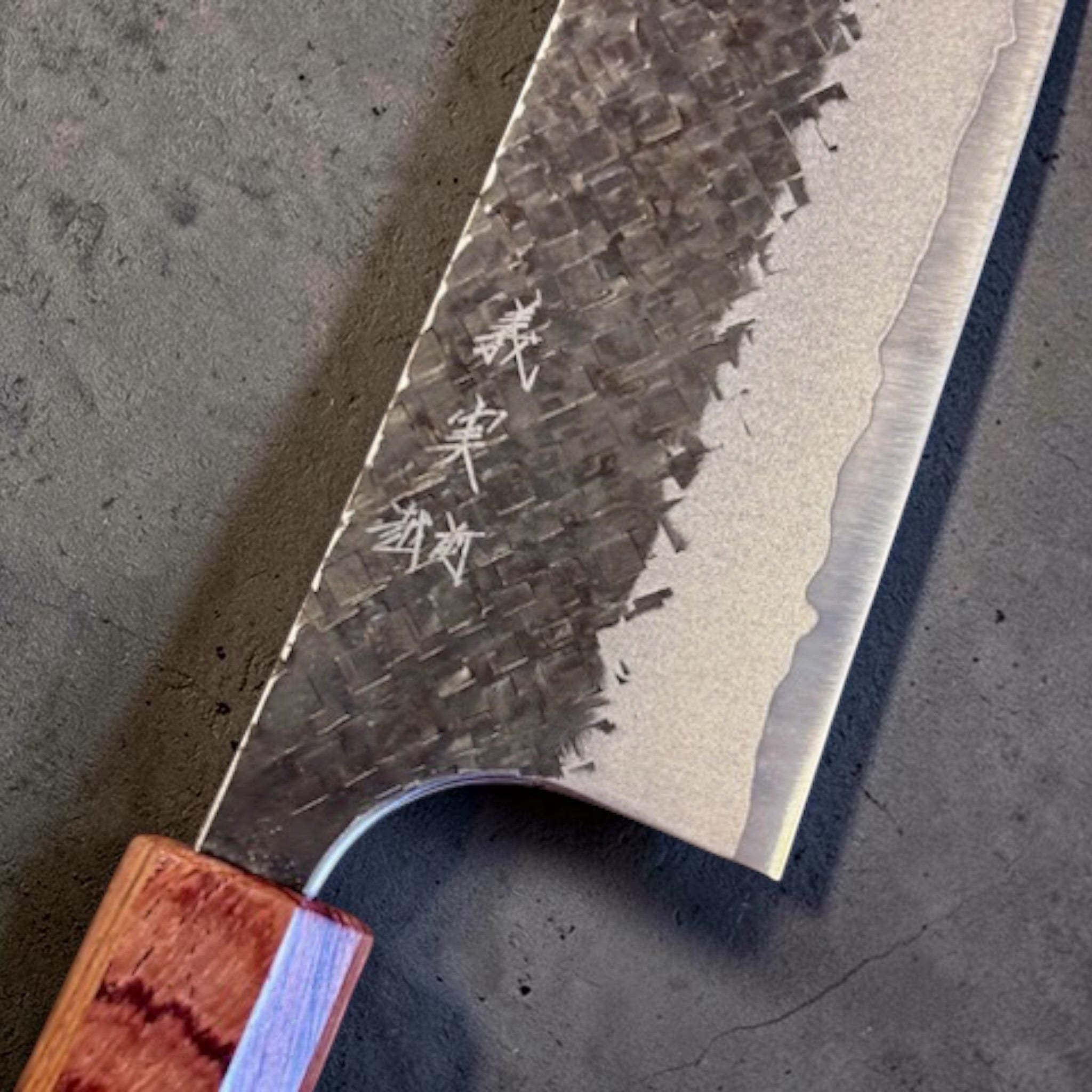 Yoshimi Kato Aogami Super Kurouchi Kaku-Tsuchime Gyuto 240mm, close-up of kanji and square-hammered finish.