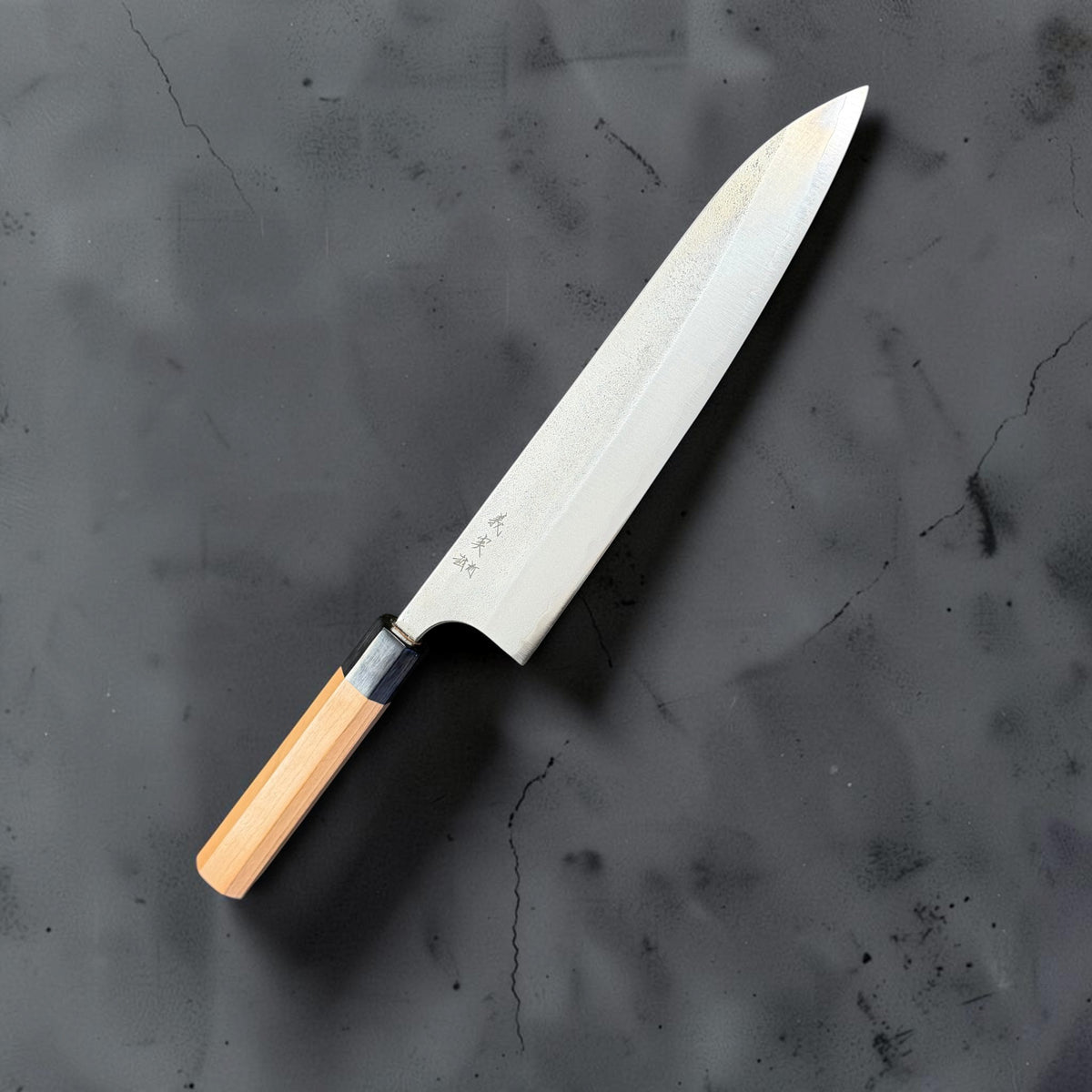 Yoshimi Kato Aogami Super Nashiji 240mm gyuto, angled front view with a light wood octagonal handle and black ferrule.