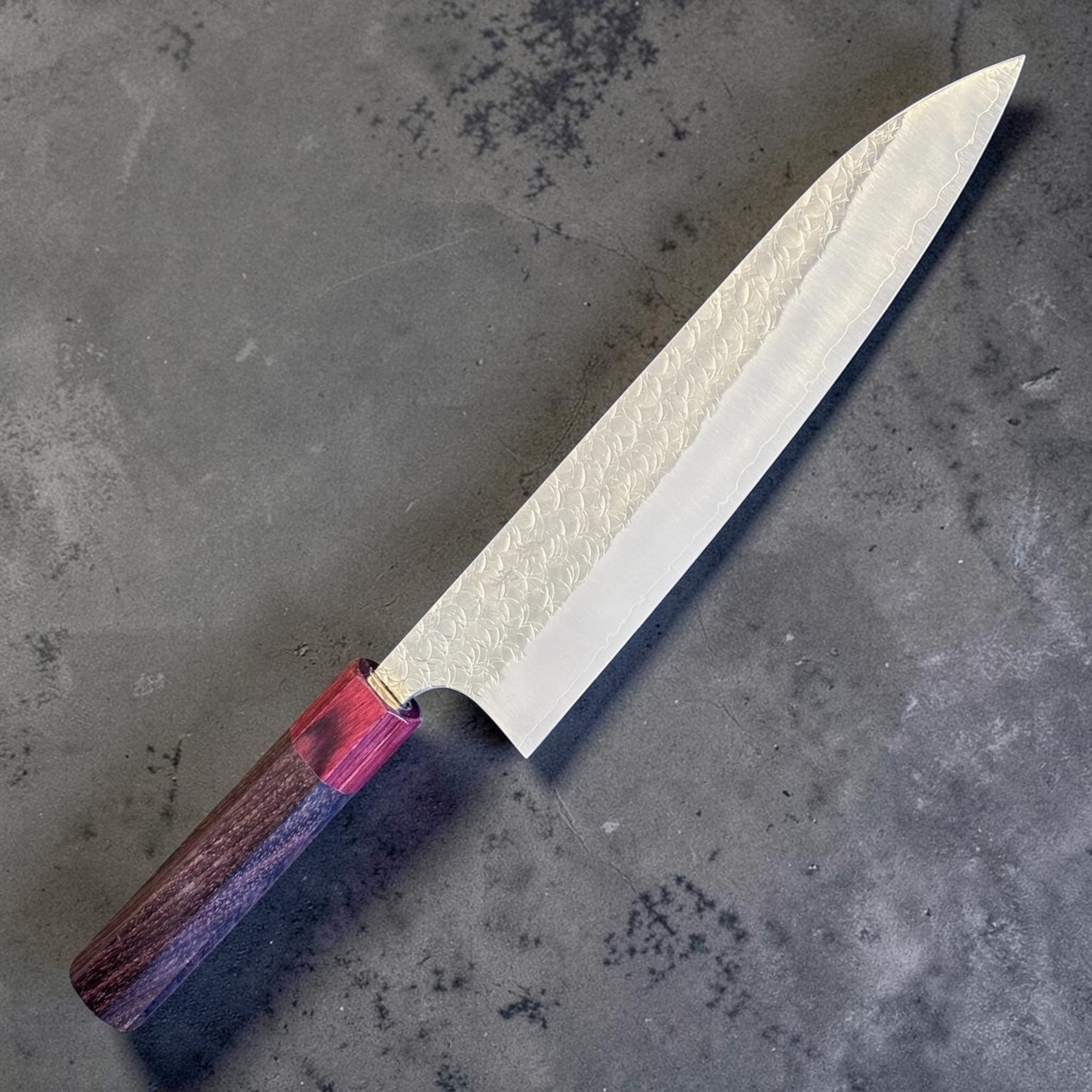 Yoshimi Kato Minamo SG2 Gyuto 210 mm, angled view highlighting the polished blade and red handle ferrule.