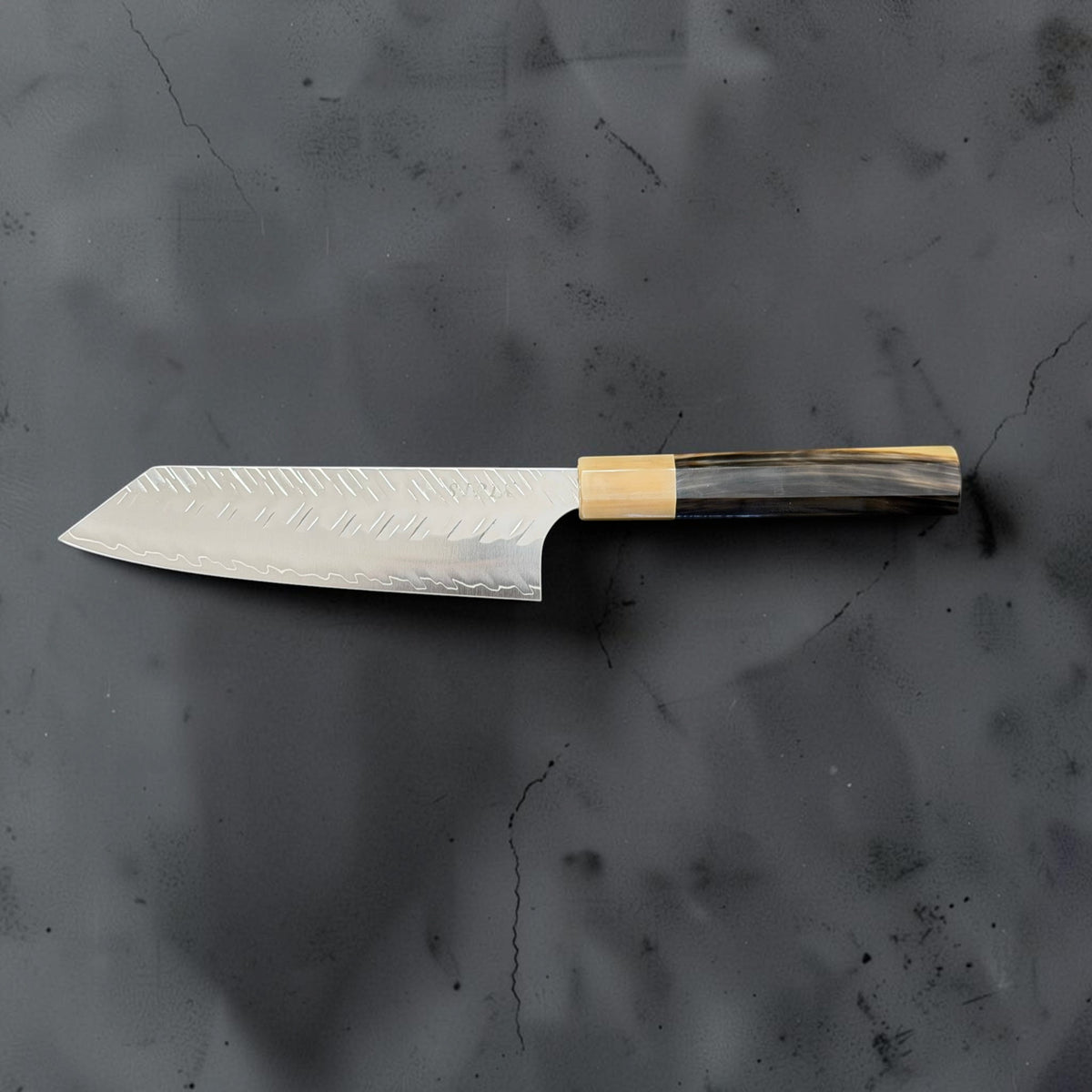 Reverse blade profile of Yoshimi Kato SG-STRIX Bunka showing hammered finish and Prisma handle