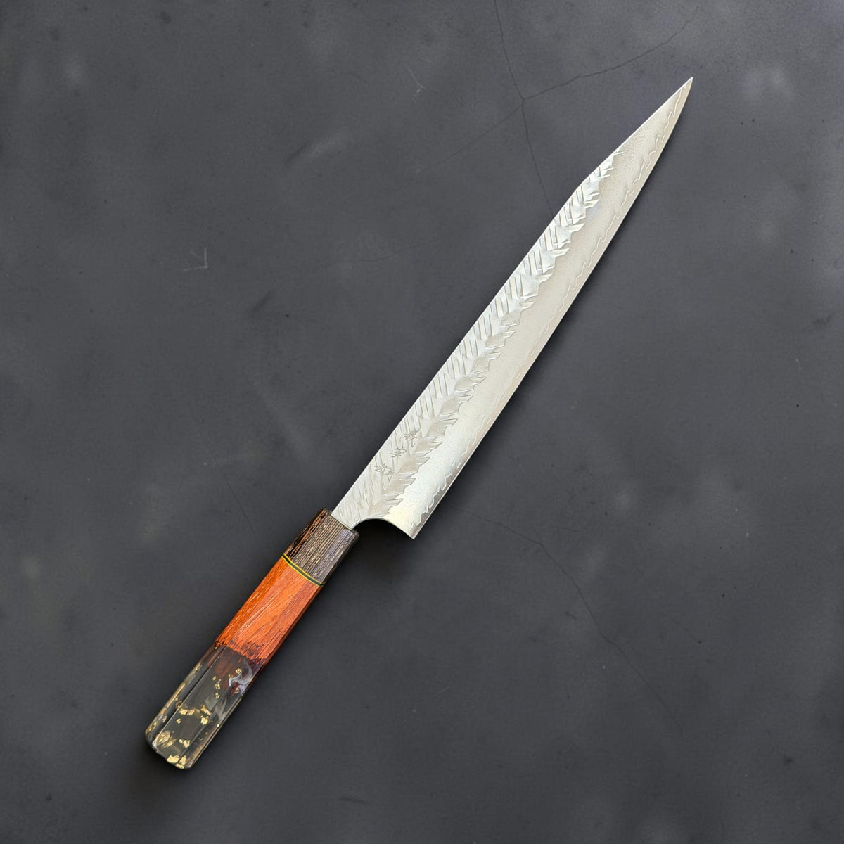Yoshimi Kato SG-STRIX V-Tsuchime 270mm sujihiki with orange wood, dark striped ferrule and black resin with gold-colored flecks, engraved side