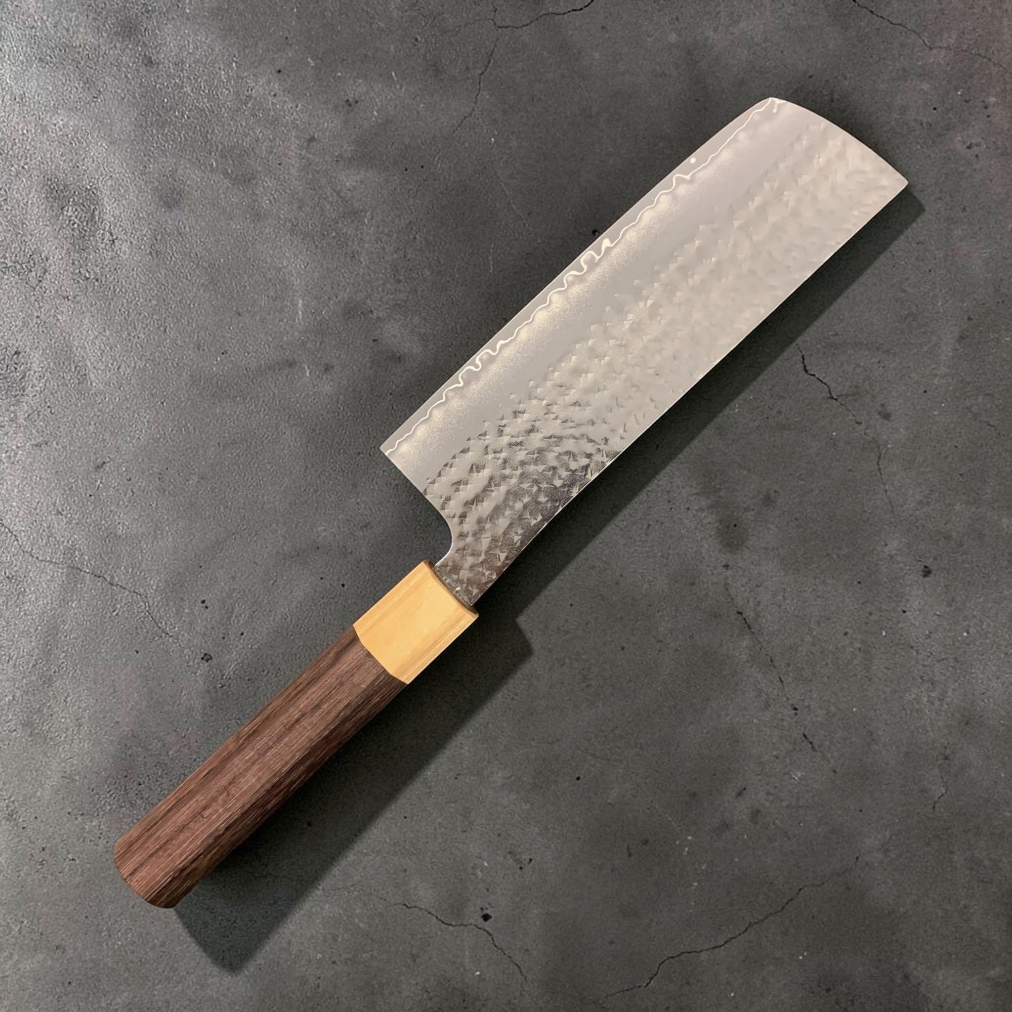 Yu Kurosaki Senko SG2 Ei Nakiri 165 mm, reverse side three-quarter view showing hammered tsuchime cladding, subtle hamon-like cladding line, and octagonal wa handle.