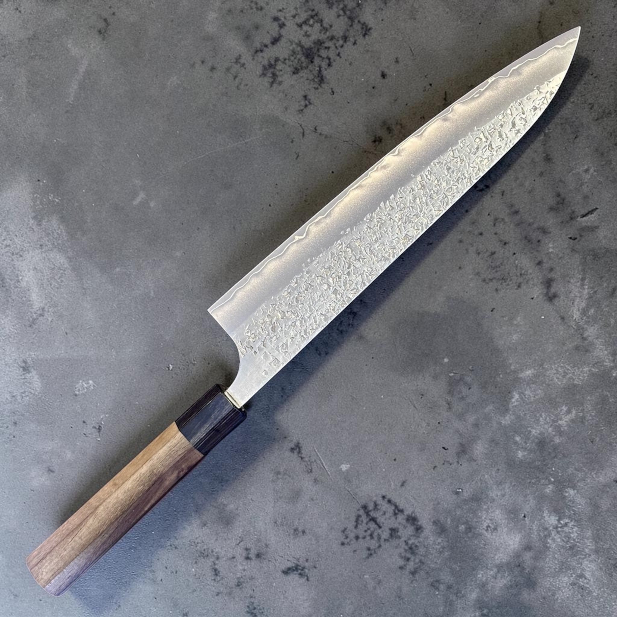 Yu Kurosaki Shizuku SG2 Gyuto 240 mm, angled product view highlighting the Shizuku hammered finish and pointed gyuto profile.