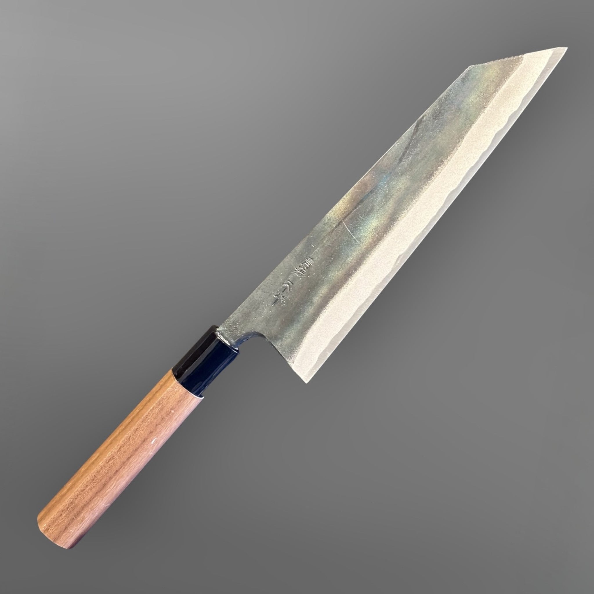 Zakuri AS Kurouchi Bunka 180 mm with kurouchi finish and wa handle, angled product photo showing the bunka tip and blade finish.