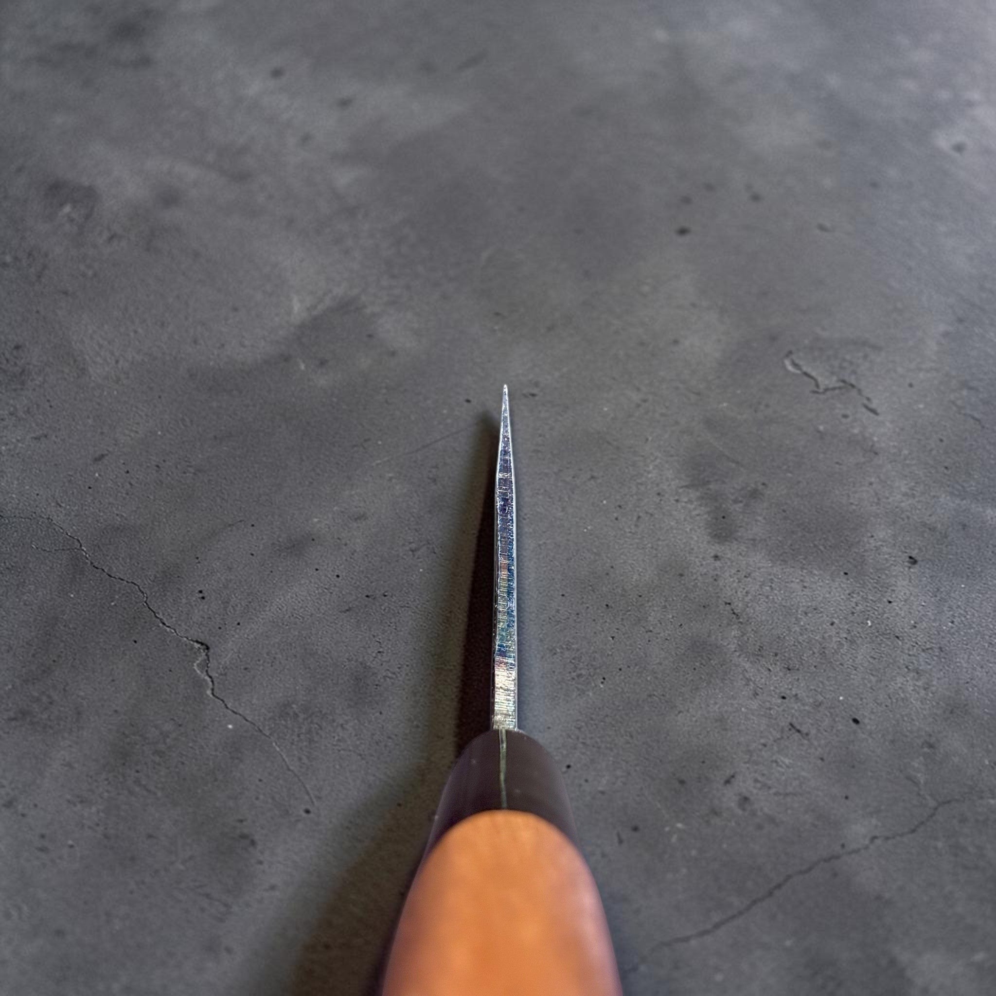 Zakuri AS Kurouchi Bunka 180 mm with kurouchi finish and wa handle, choil view showing spine and edge geometry.