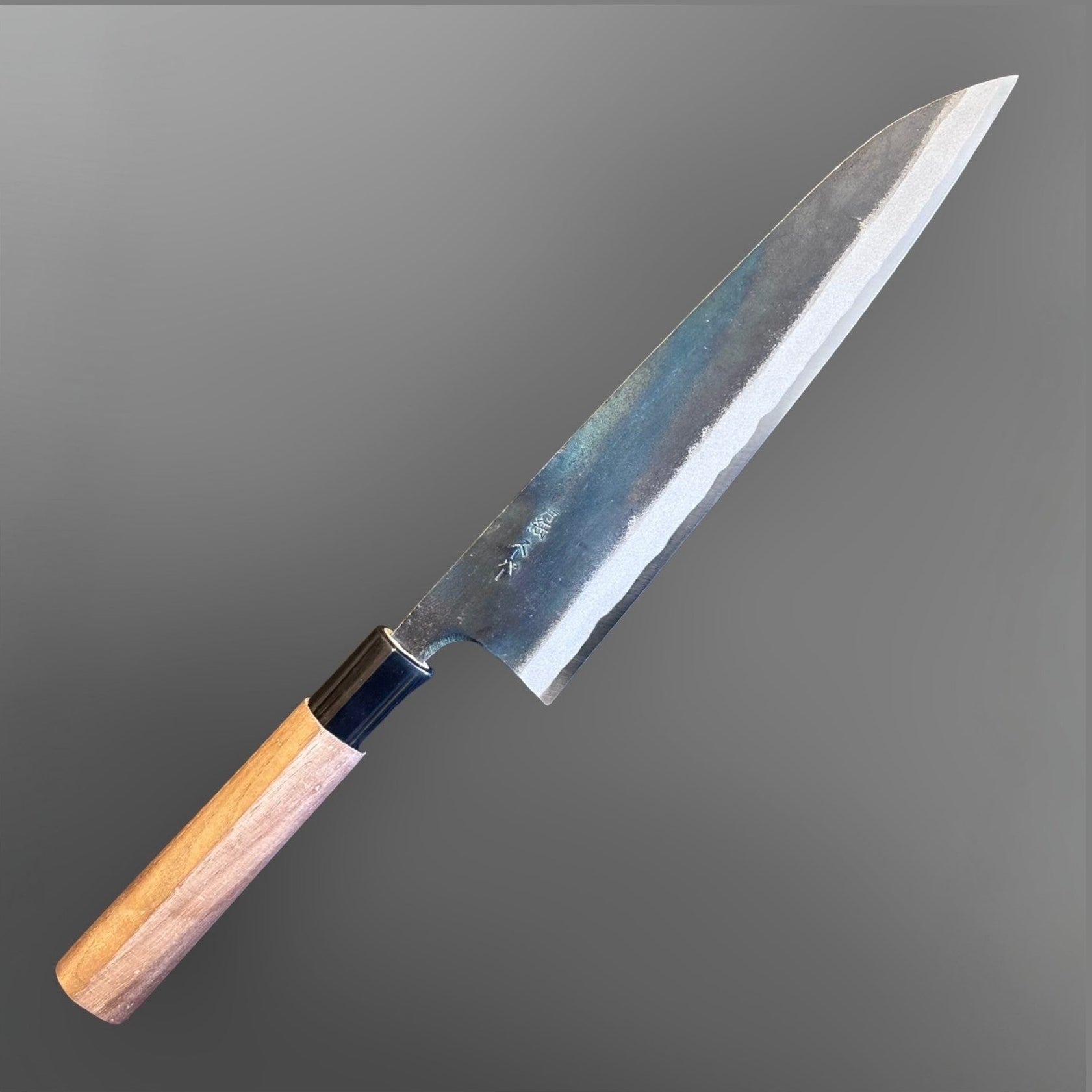 Zakuri AS Kurouchi Gyuto 210 mm, angled full-knife view showing the kurouchi blade finish and wa handle.