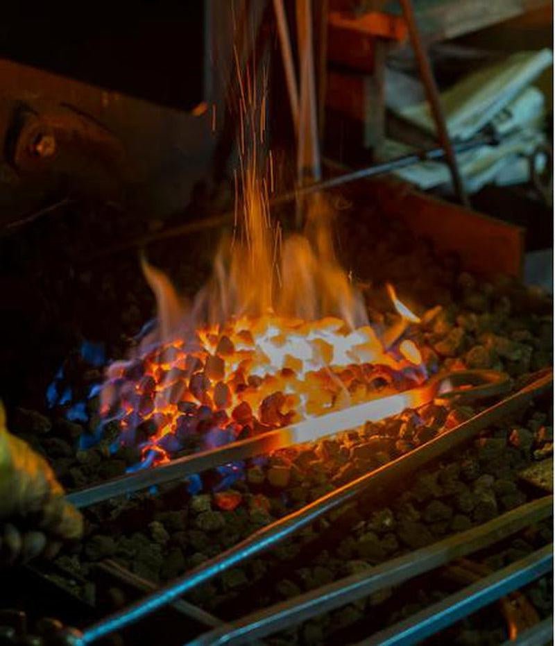 Heated steel in a charcoal forge during Japanese knife making