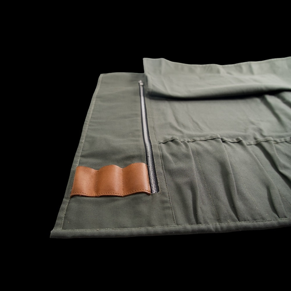 Canvas knife roll showing leather holders for kitchen tools
