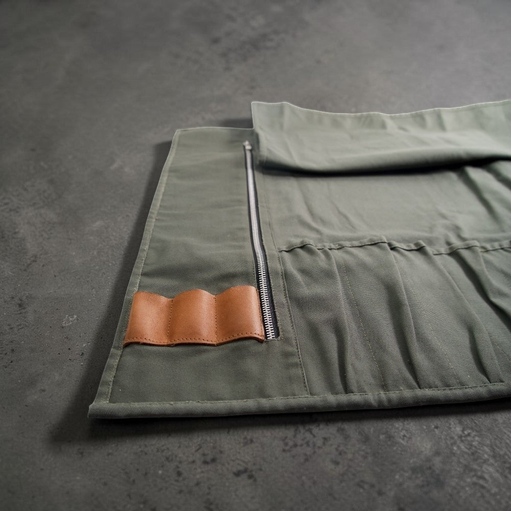 Canvas knife roll showing leather holders for kitchen tools