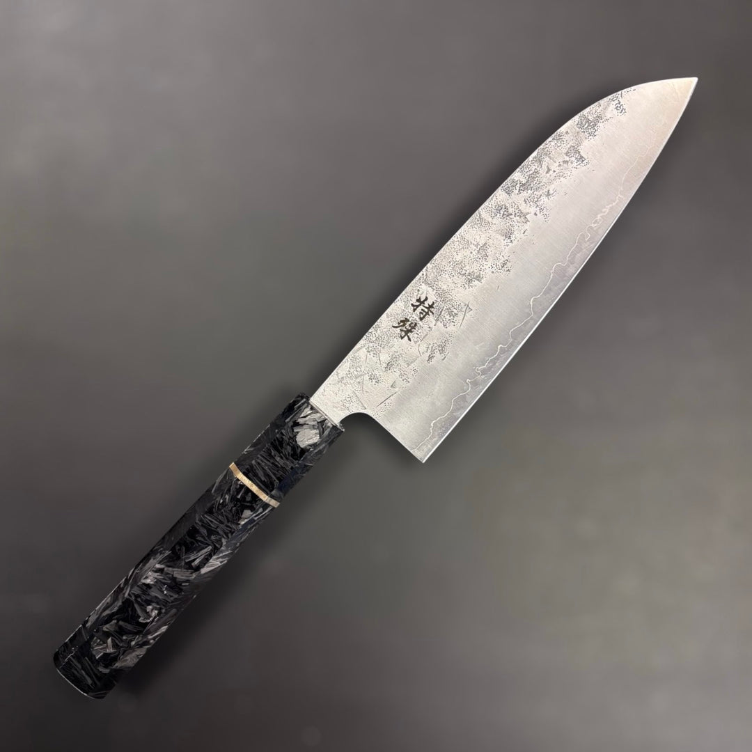 Tokushu Knife SLD Washiji Santoku showing off kanji on grey blurred background.