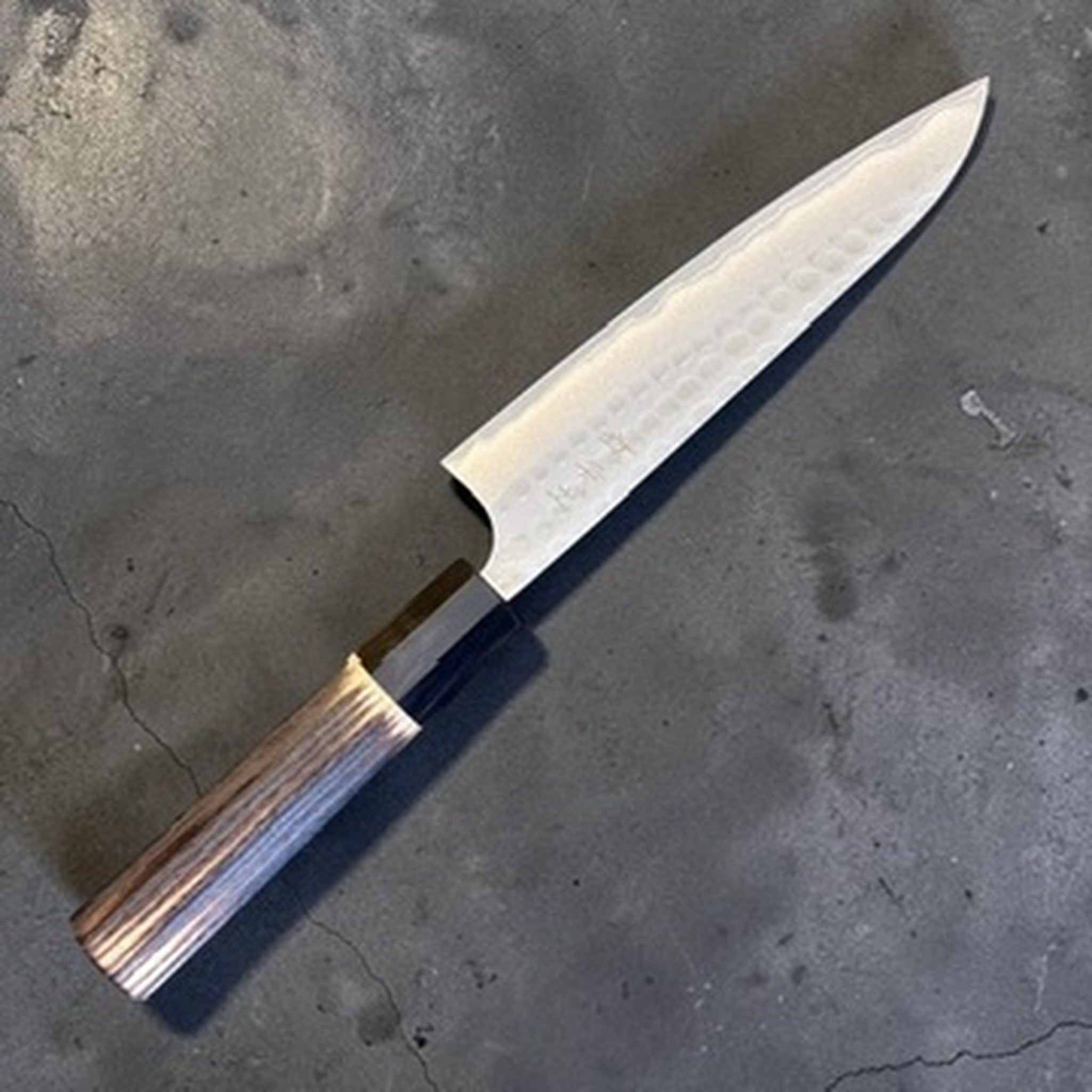 Anryu AO #2 Kurouchi Tsuchime Petty 150 mm with burnt wood handle and black buffalo horn ferrule, alternate angled blade view.