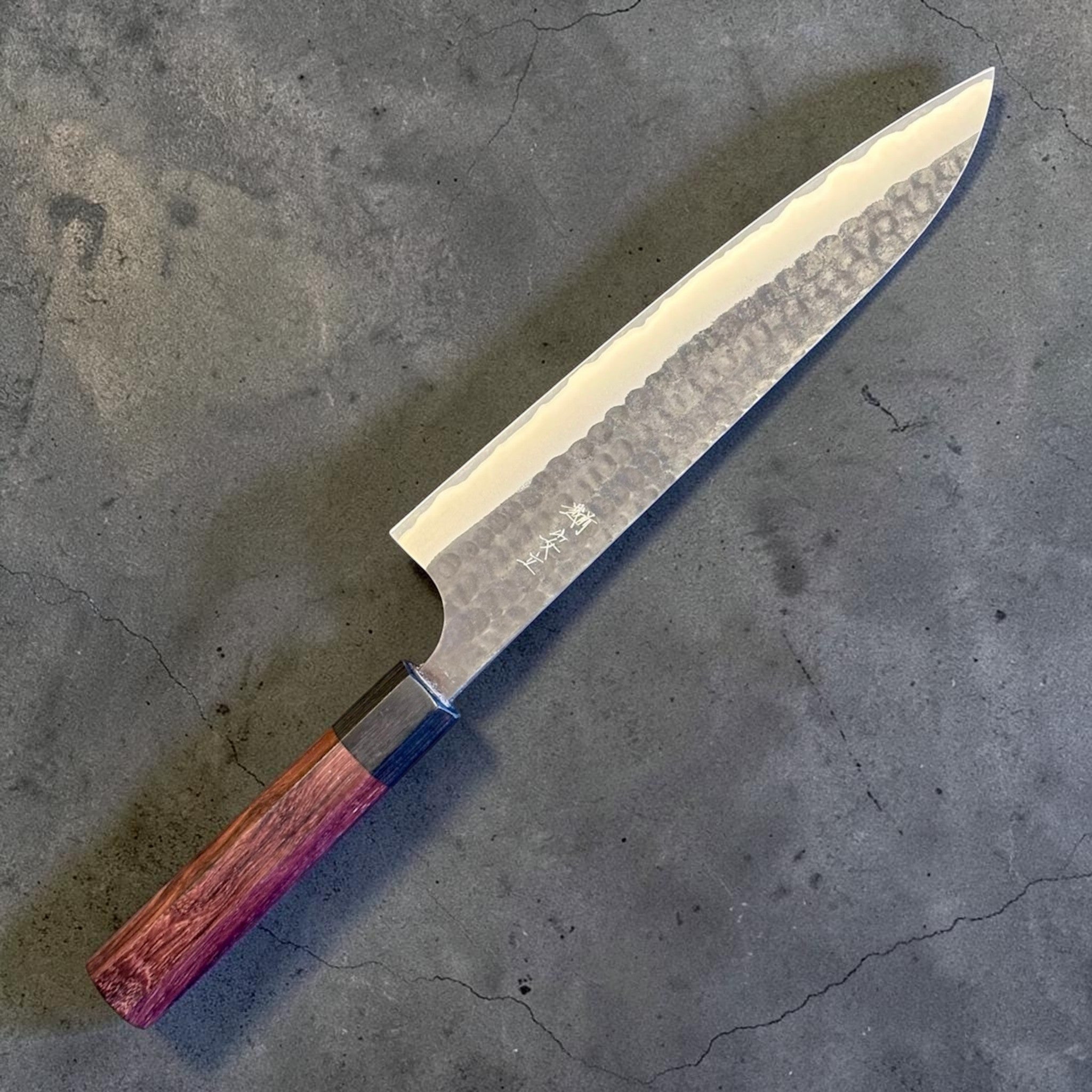 Anryu Aogami Super Kurouchi Gyuto 210 mm, full side profile with kurouchi finish, hammered tsuchime texture, and purple-toned octagonal wa handle.