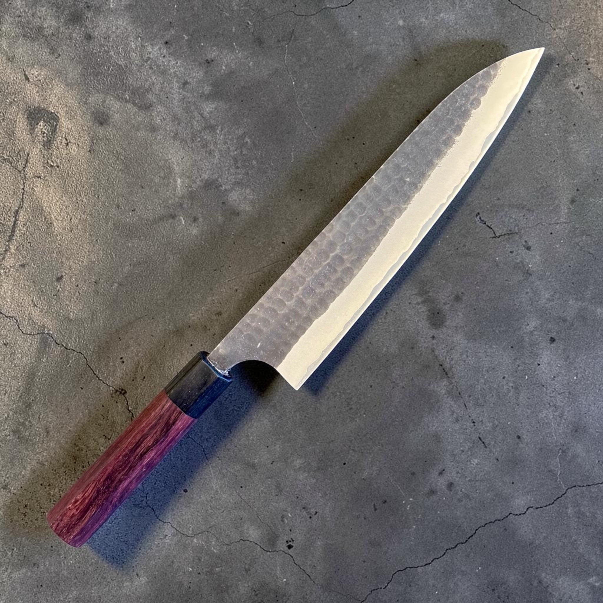 Anryu Aogami Super Kurouchi Gyuto 210 mm, angled reverse-side close-up emphasizing the blade finish, distal taper, and octagonal wa handle.
