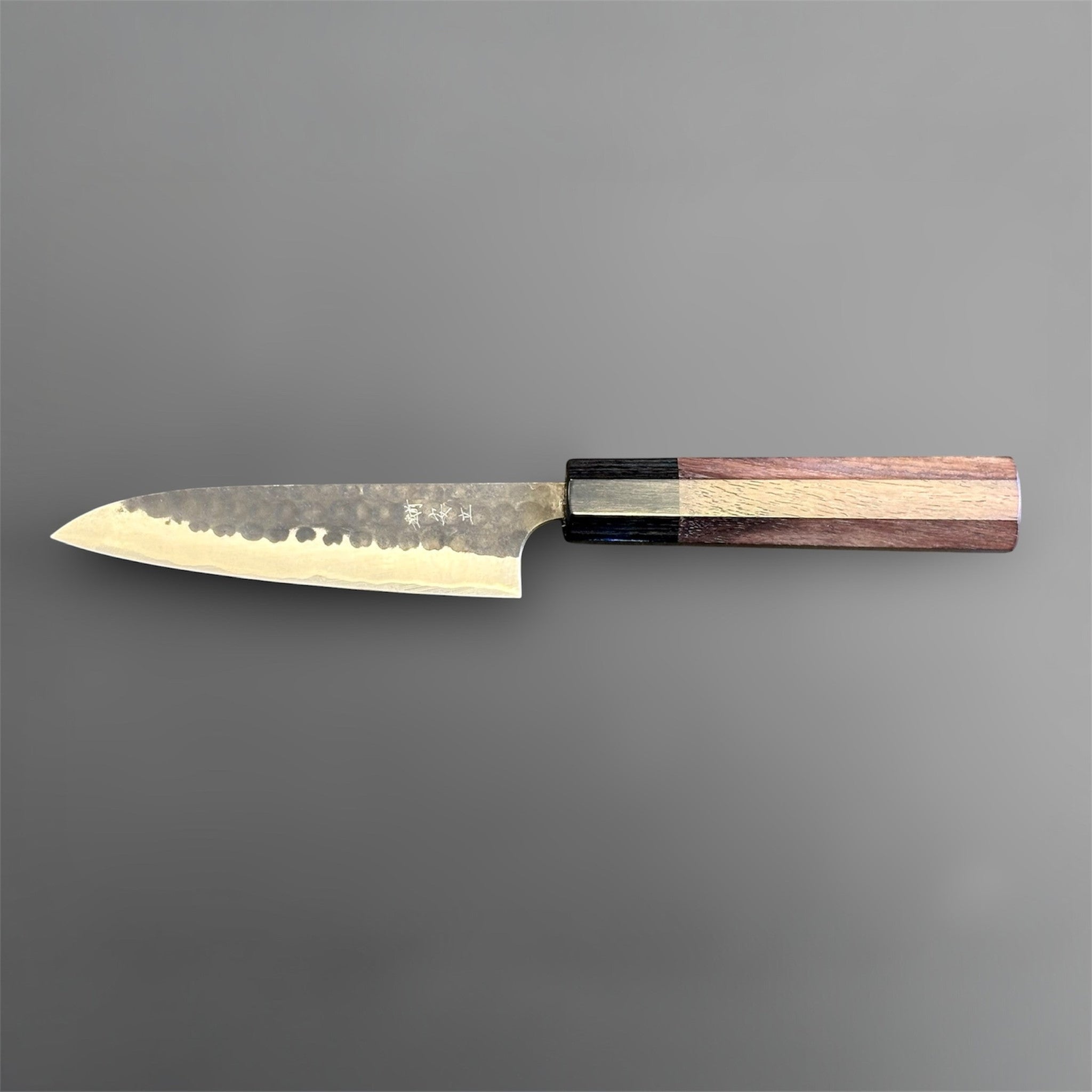 Anryu Aogami Super Kuro Tsuchime Petty 120 mm with rosewood octagon handle, reverse full profile highlighting the kanji engraving and dark hammered blade finish.