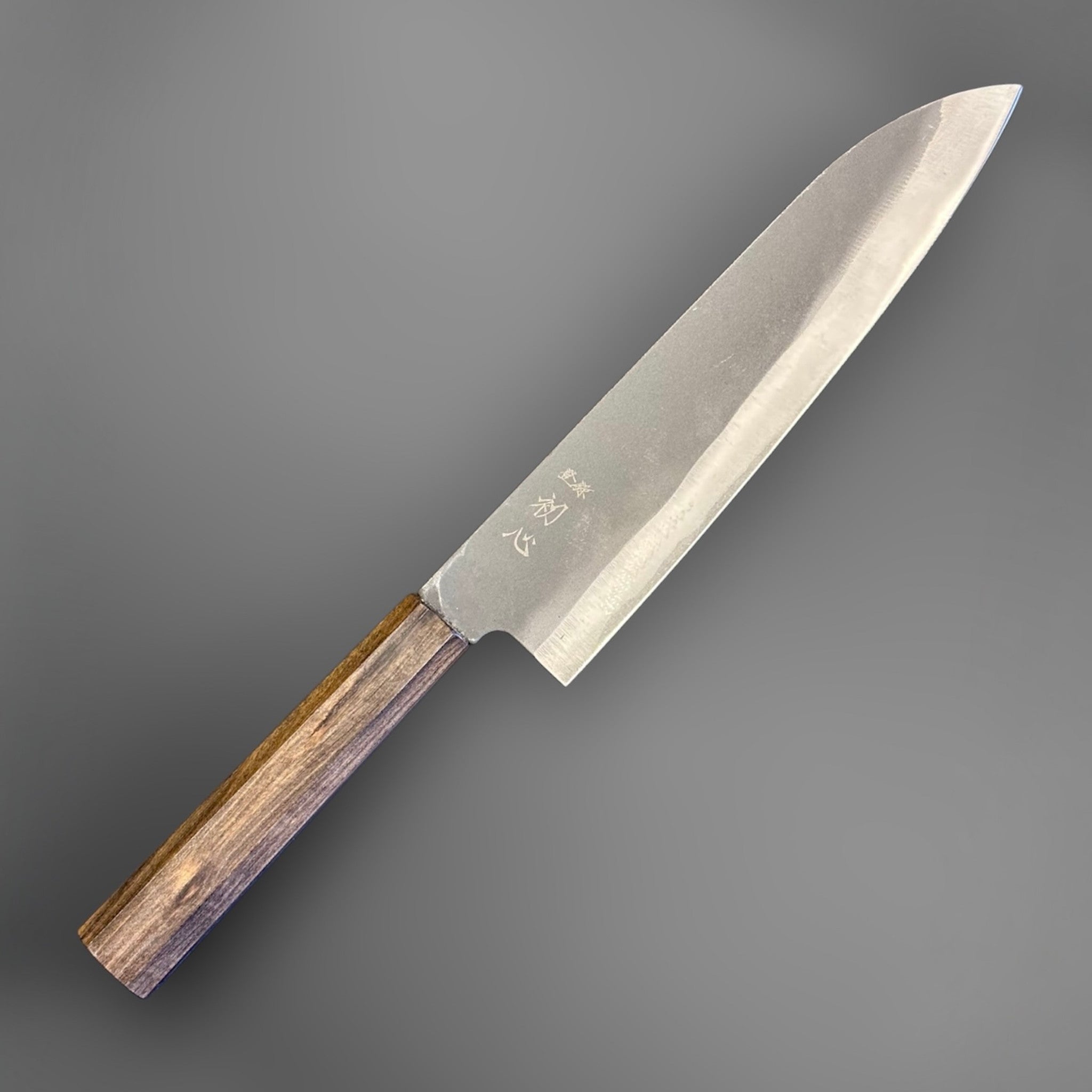 Hatsukokoro Blue #2 Kurouchi Gyuto 220 mm with mono ebony handle, angled full view of the blade and handle.