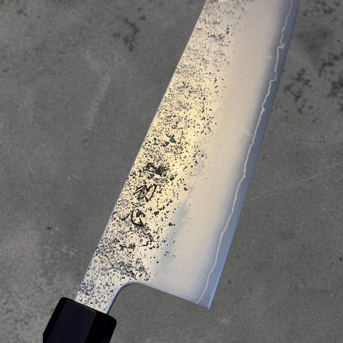 Close-up of the Nashiji finish, blade markings, and polished bevel on the Hatsukokoro Ginrei Ginsan Nashiji 210mm kiritsuke with ebony handle.