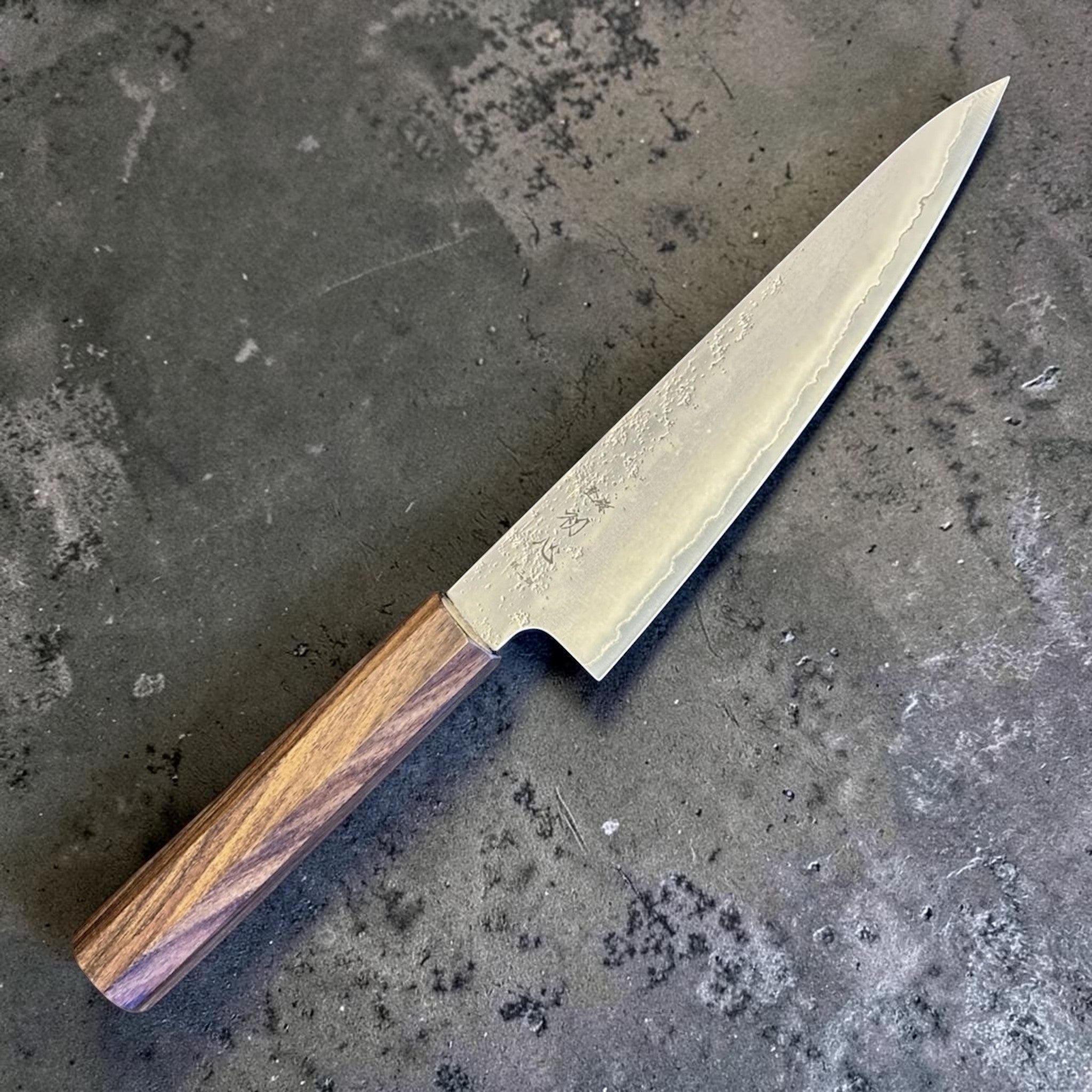 Hatsukokoro Ginrei Silver #3 Ko Santoku 150 mm with mono ebony handle, angled full-knife product view.