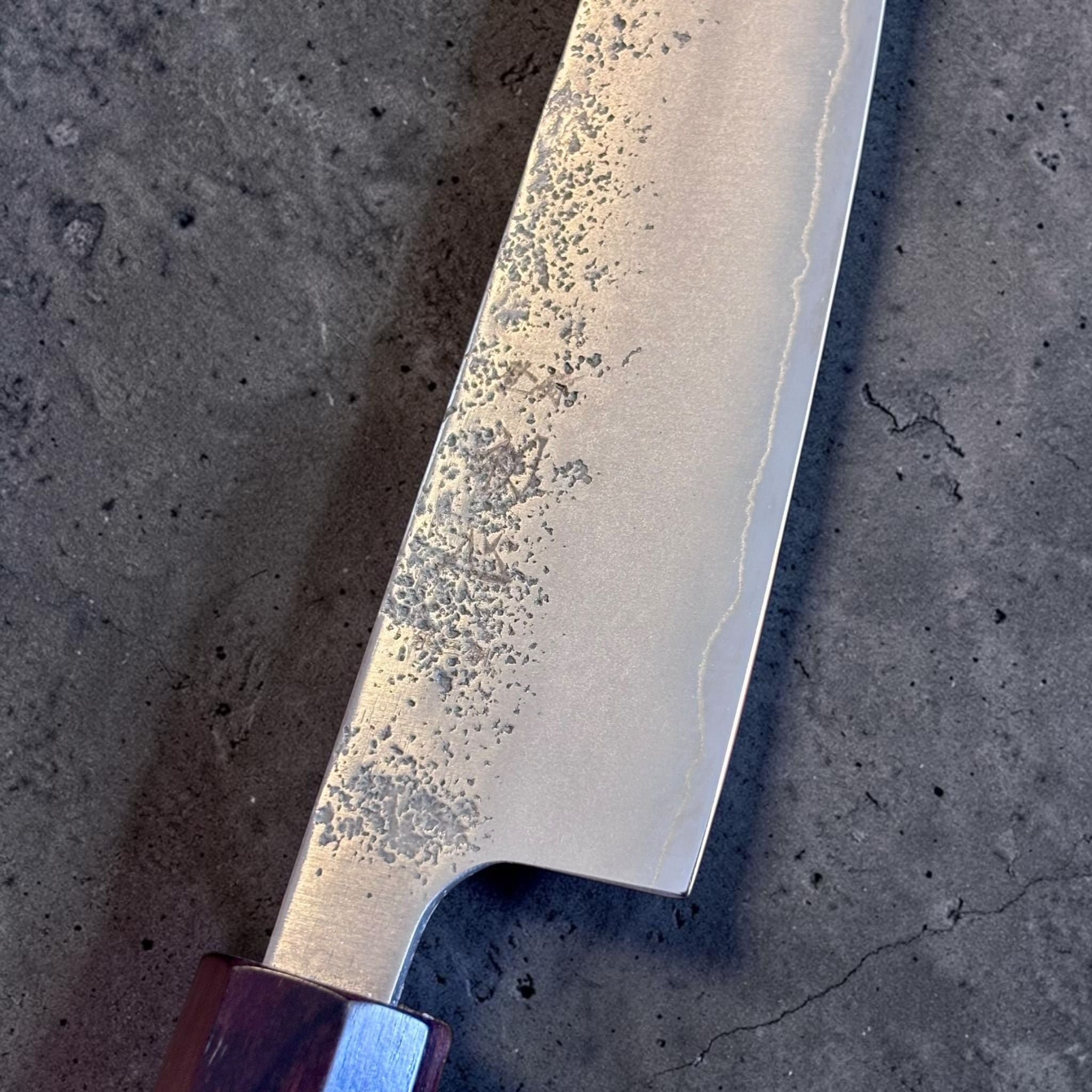 Hatsukokoro Ginrei Silver #3 Petty 130 mm, close-up of hammered blade texture and kasumi finish.