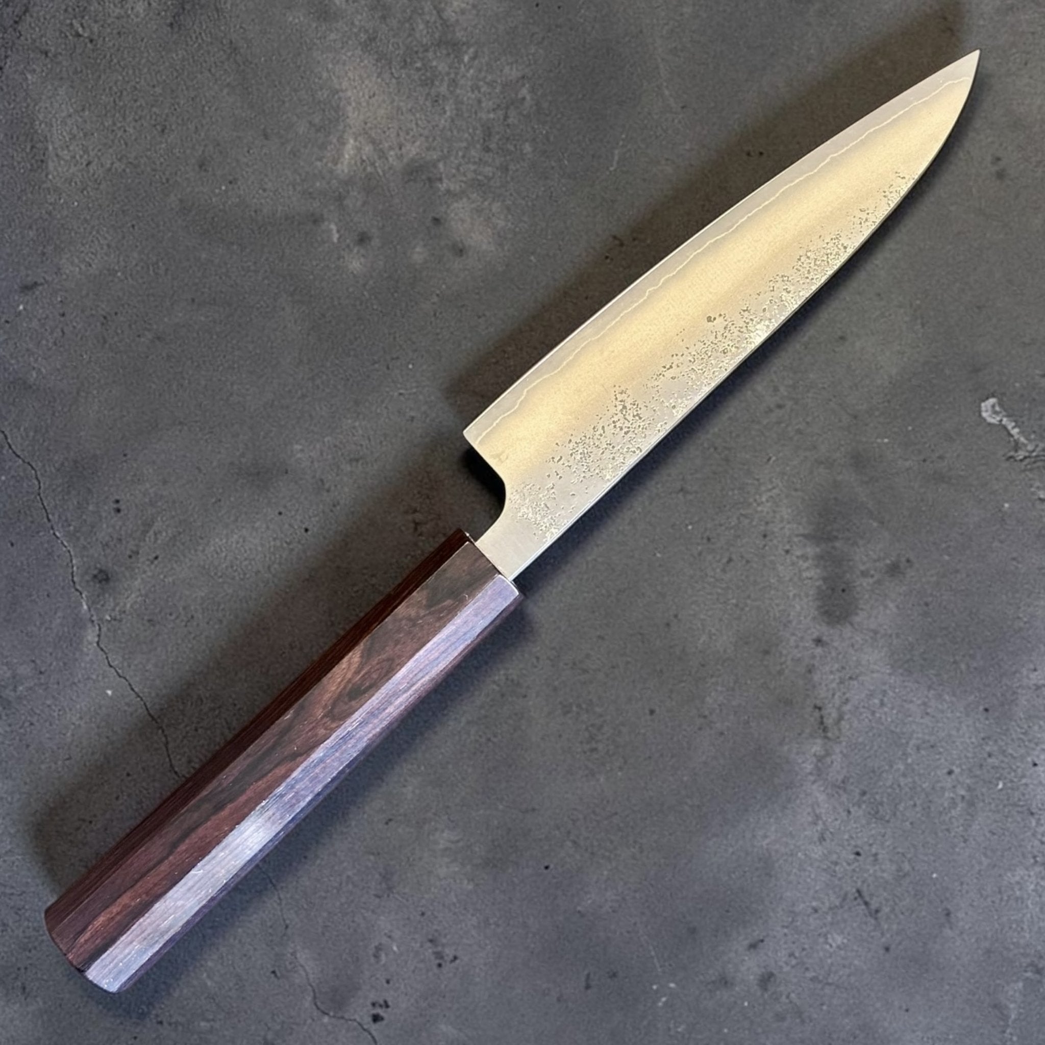 Hatsukokoro Ginrei Silver #3 Petty 130 mm with mono ebony handle, angled blade and handle view.