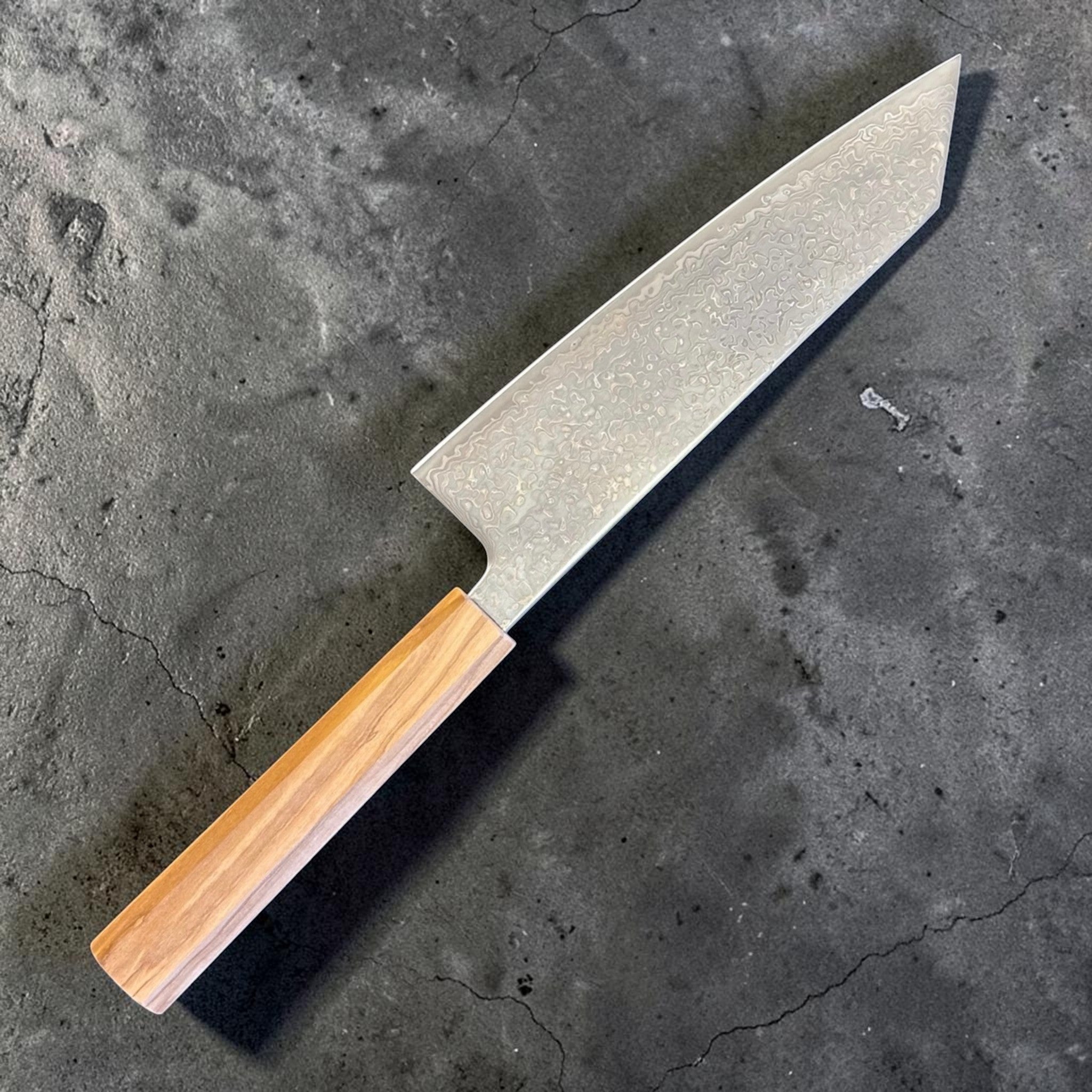 Hatsukokoro Hikari SLD Damascus Kurozome Bunka 170 mm with olive wood handle, angled reverse-side view of the blade and handle.