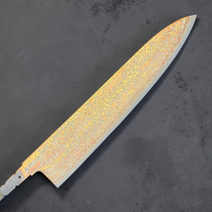 Hatsukokoro Hinotori V-Toku2 Rainbow Damascus Gyuto 240mm blade only, front side showing the long chef knife profile and etched copper and brass Damascus.