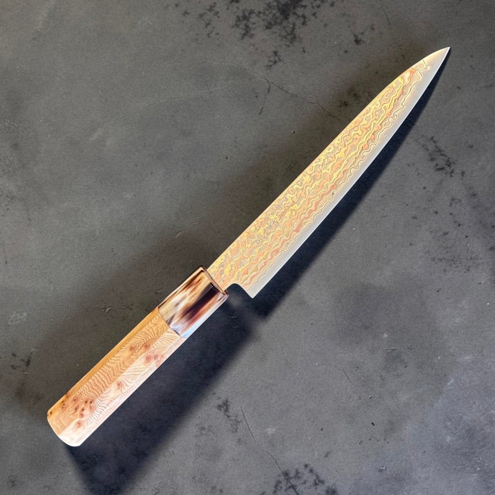Hatsukokoro Hinotori V-Toku2 Rainbow Damascus Petty 150mm with cypress wood and buffalo horn wa handle, angled right-side view.