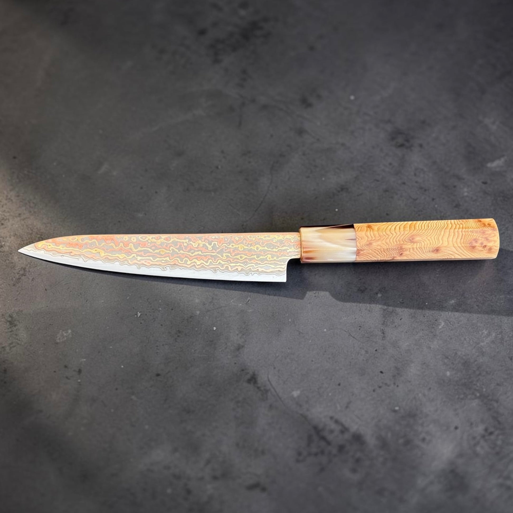 Full left-side profile of the Hatsukokoro Hinotori V-Toku2 Rainbow Damascus 150mm petty knife with cypress and buffalo horn handle.