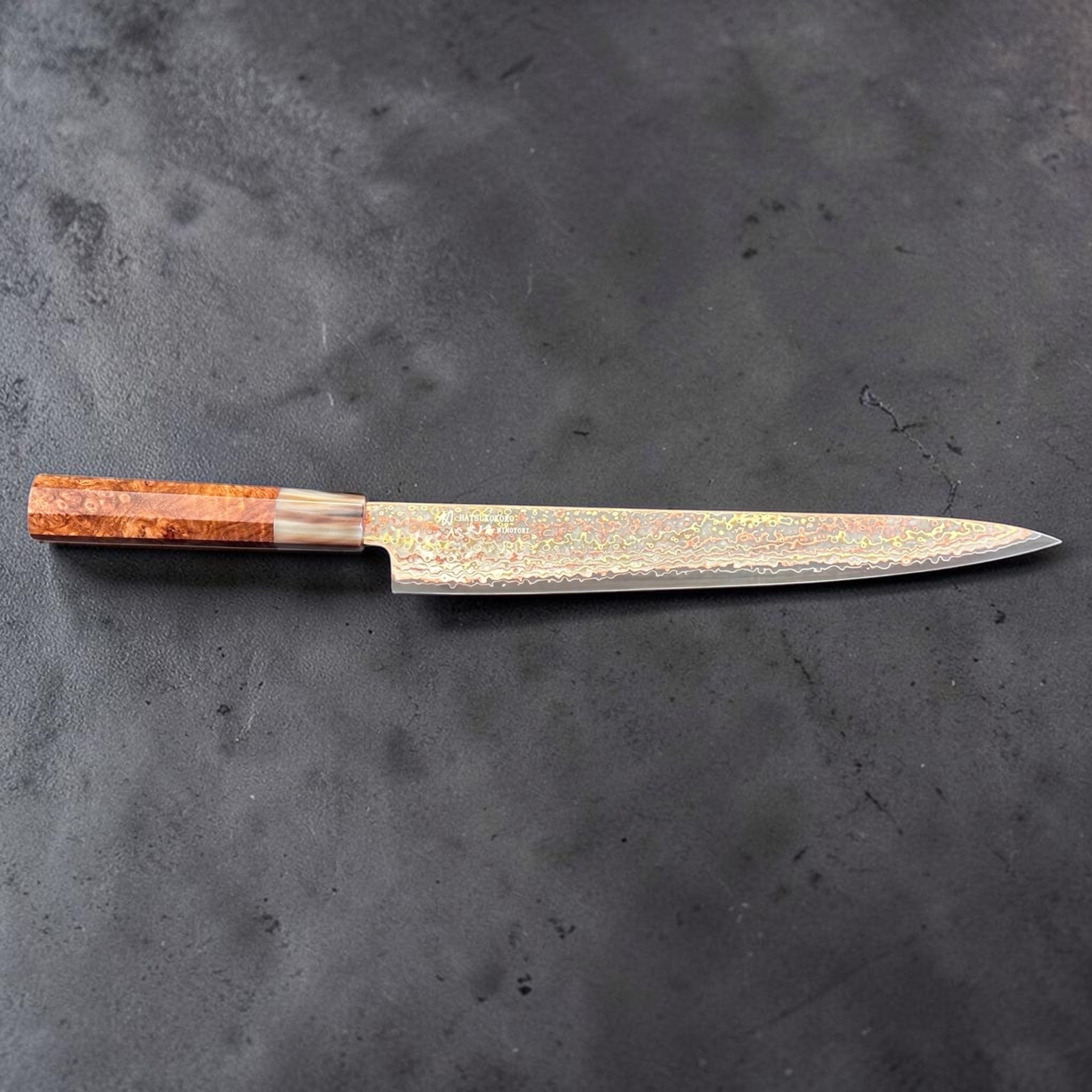 Hatsukokoro Hinotori V-Toku2 Rainbow Damascus Sujihiki 270 mm with amboyna burl wa handle, full side profile on gray background.