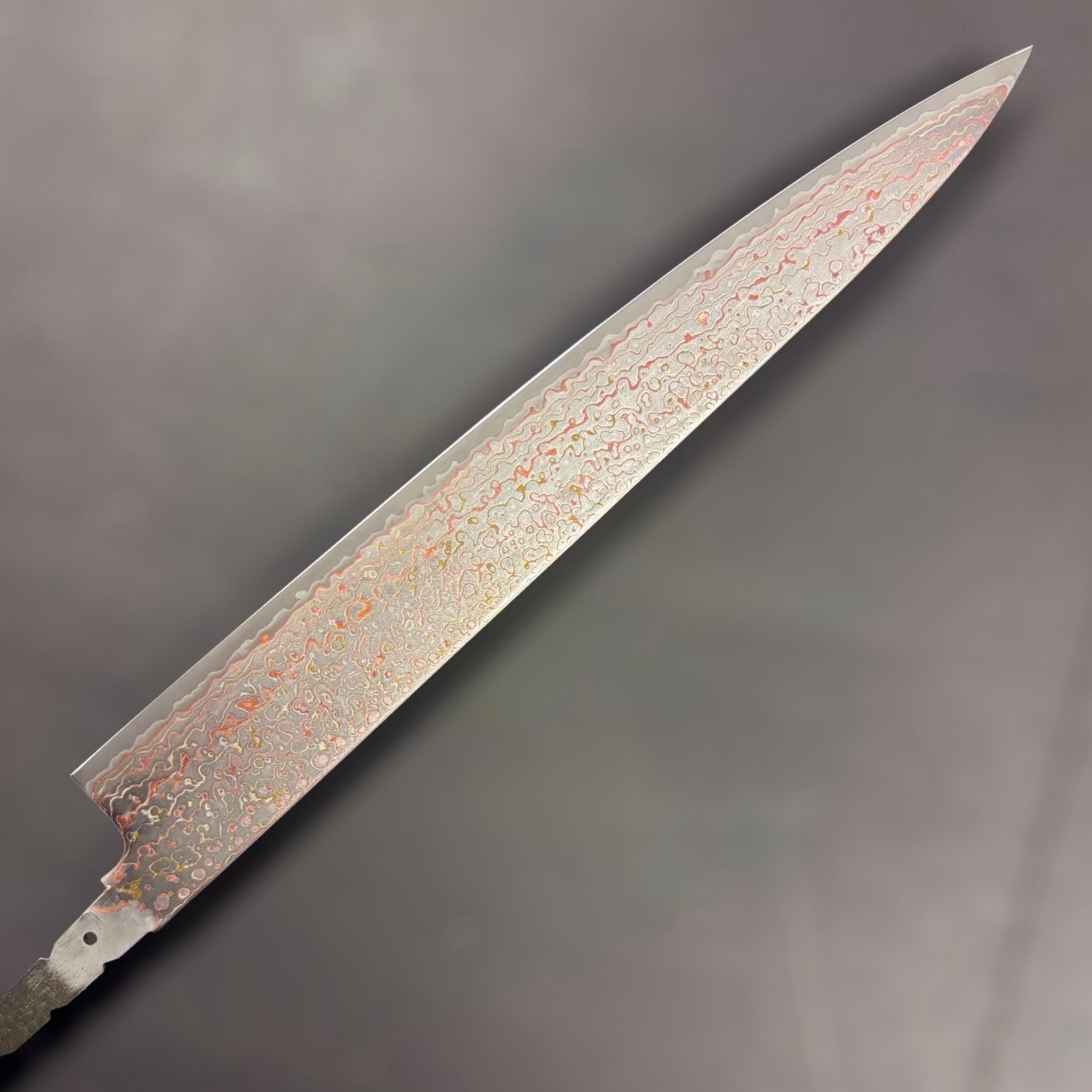 Hatsukokoro Kujaku V-Toku2 Rainbow Damascus Sujihiki 270mm, left face of blade