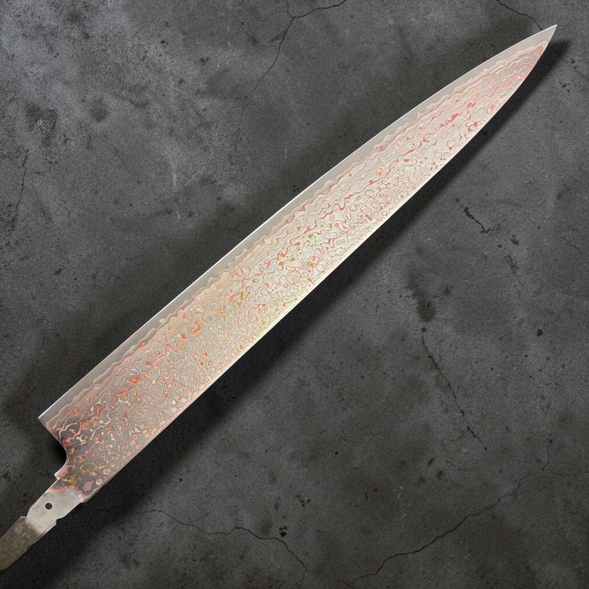 Hatsukokoro Kujaku V-Toku2 Rainbow Damascus Sujihiki 270mm, left face of blade
