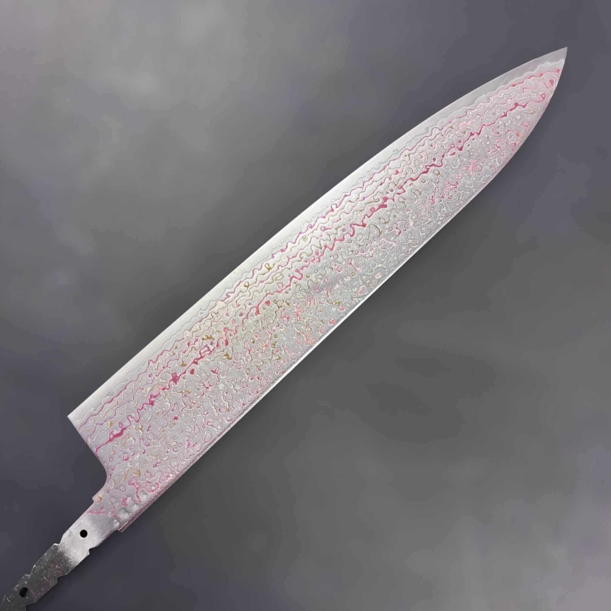 Hatsukokoro Kujaku V-Toku2 Rainbow Damascus Gyuto 240 mm, blade face close-up showing multi-color Damascus wave pattern.